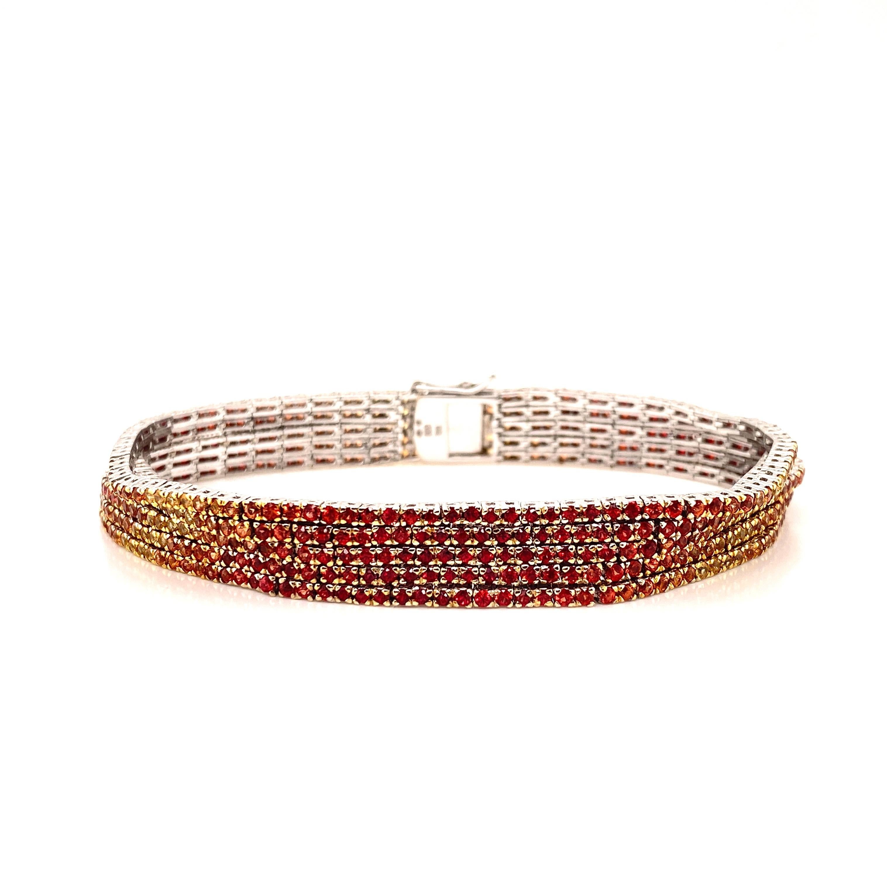 This stunning Orange Sapphire Bracelet features a spectrum of Round Orange, Red, and Yellow Sapphires.
This Bracelet is set in 18K White Gold —  is 7 inches in length and is secured with a box clasp.
Total Sapphire Weight = 10.60 Carats.
