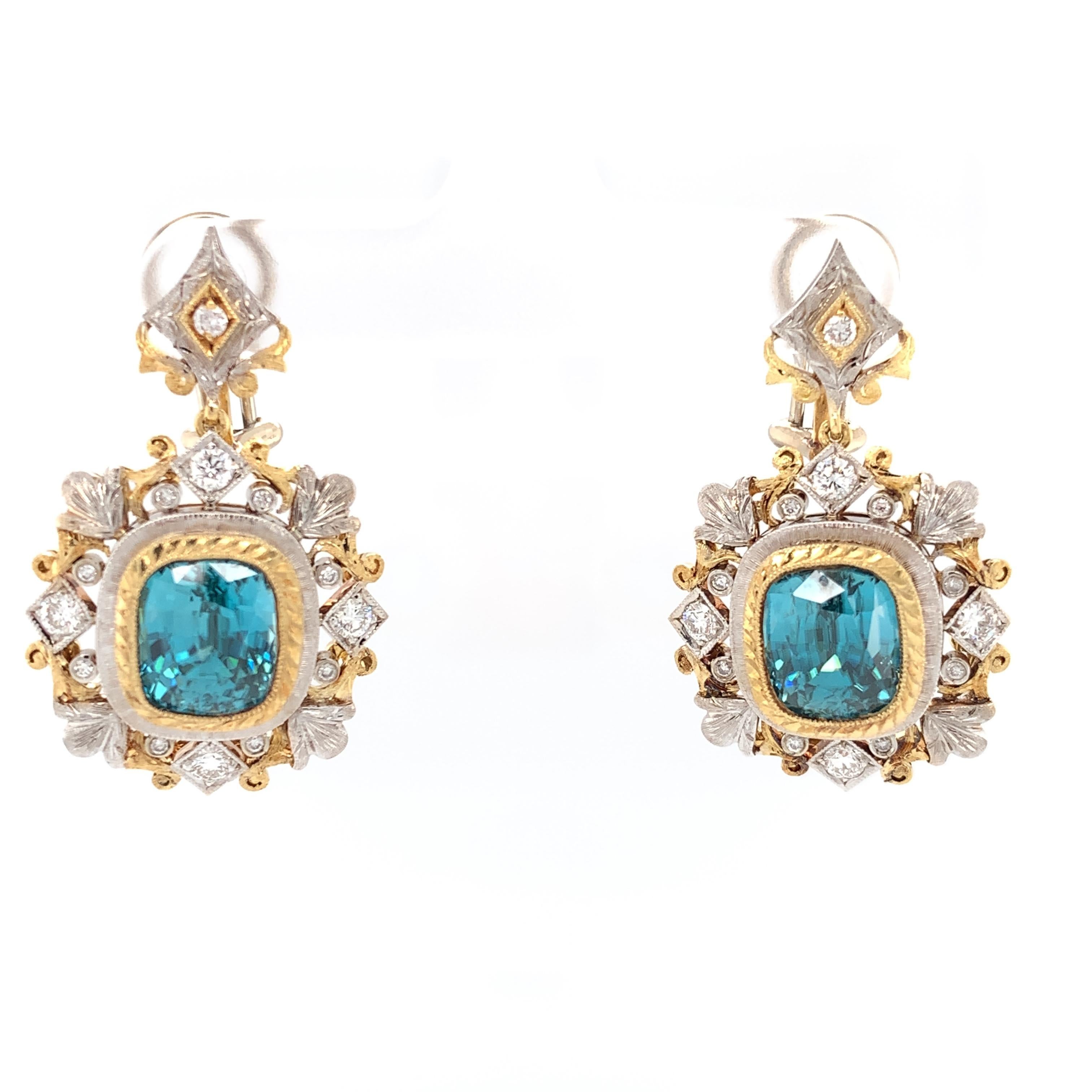 These magnificently handcrafted blue zircon and diamond earrings are breathtaking masterpieces. Blue zircon has been prized since Victorian times for its beautiful color and captivating brilliance. This perfectly matched pair of cushion-cut blue