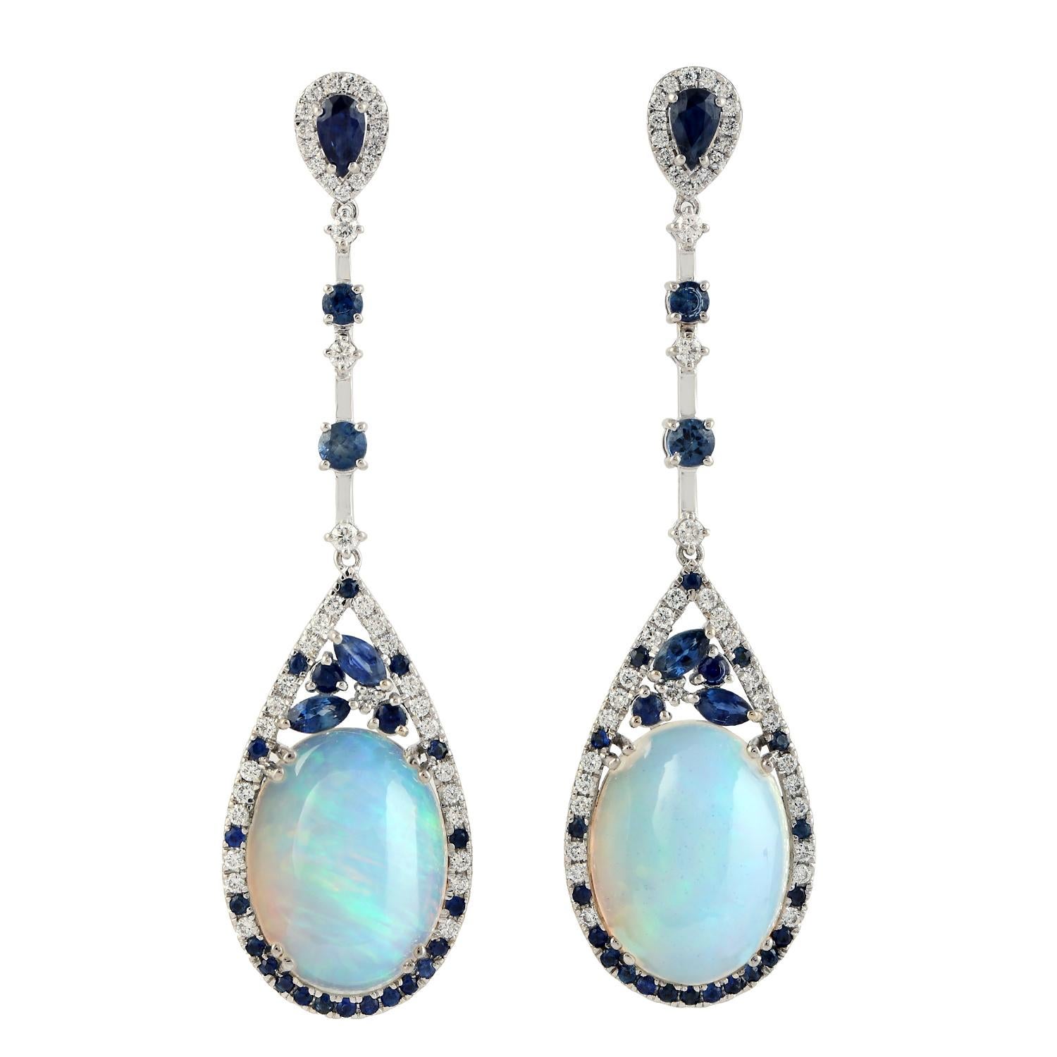 Cast in 14 karat gold. These earrings are hand set in 10.61 carats Ethiopian opal, 2.17 carats blue sapphire and .69 carats of sparkling diamonds.

FOLLOW  MEGHNA JEWELS storefront to view the latest collection & exclusive pieces.  Meghna Jewels is