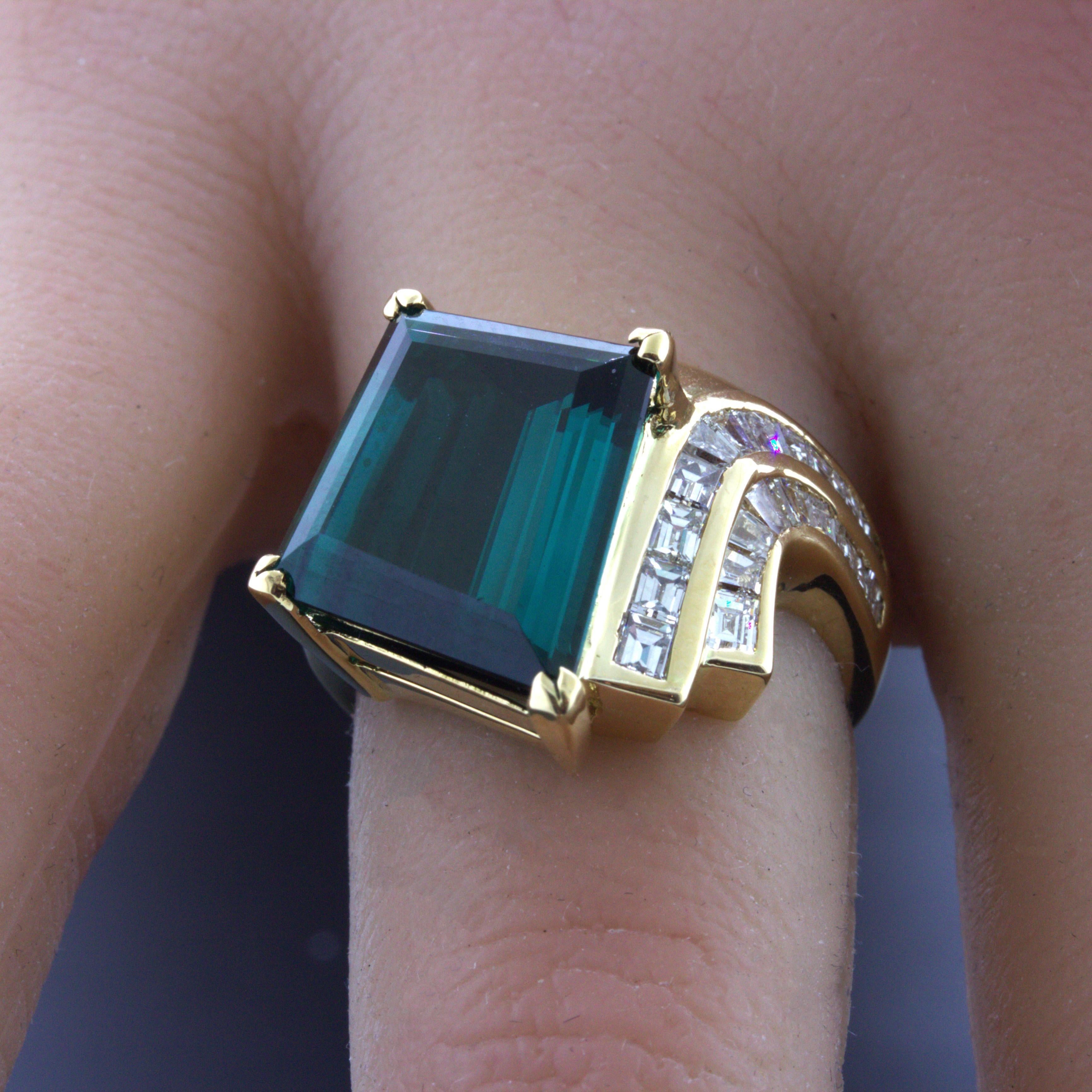 A beautiful richly colored indicolite tourmaline takes center stage! It weighs an impressive 10.62 carats and has a rich intense vivid greenish-blue color that is just so beautiful! No other gemstone can produce a color such as indicolite tourmaline