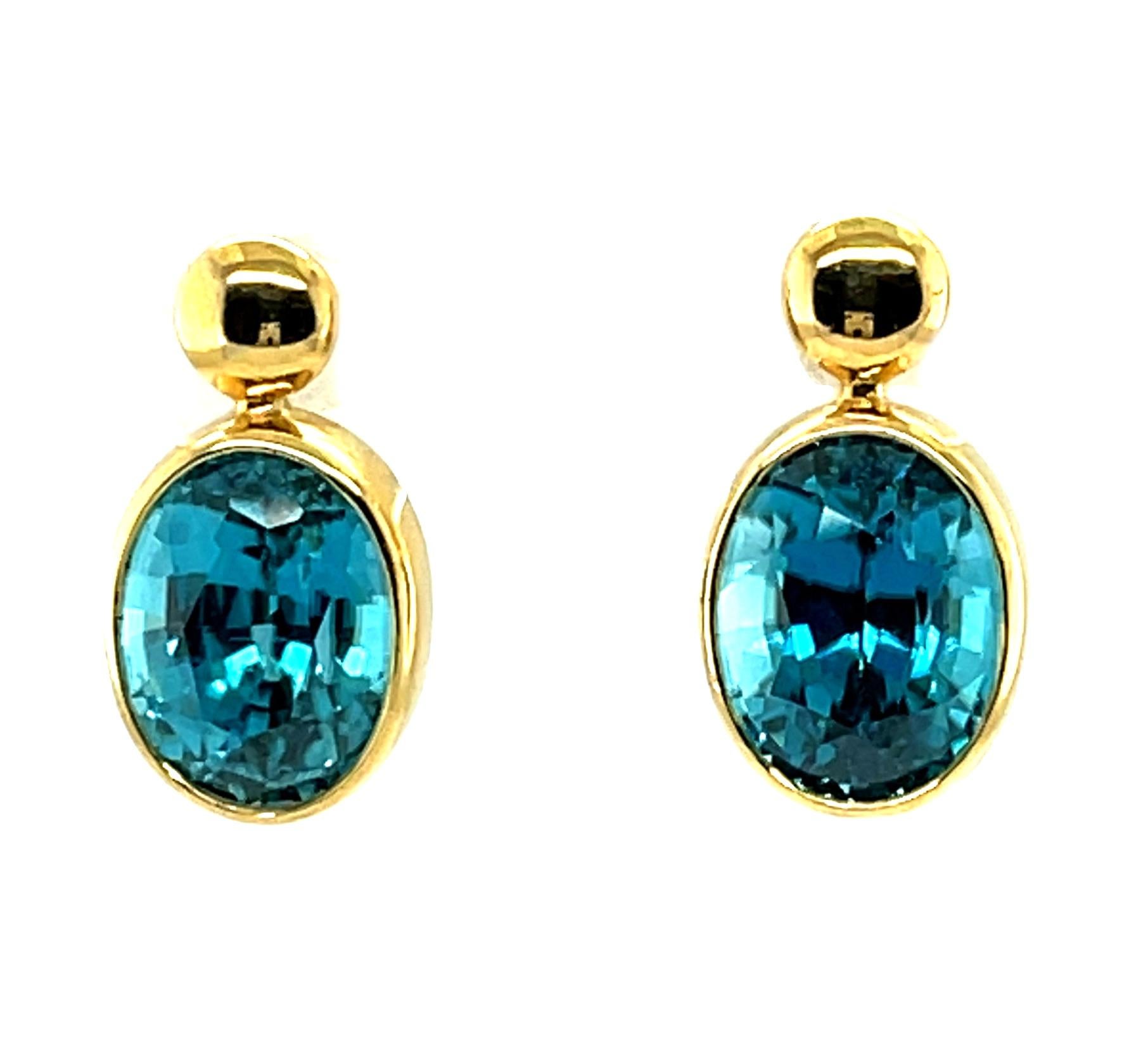 18k yellow gold bezels draw much-deserved attention to the perfect outline and color of the striking vivid blue zircon in this pair of gorgeous drop earrings. Blue zircon has been prized since the 1800's and a matched pair of this quality and