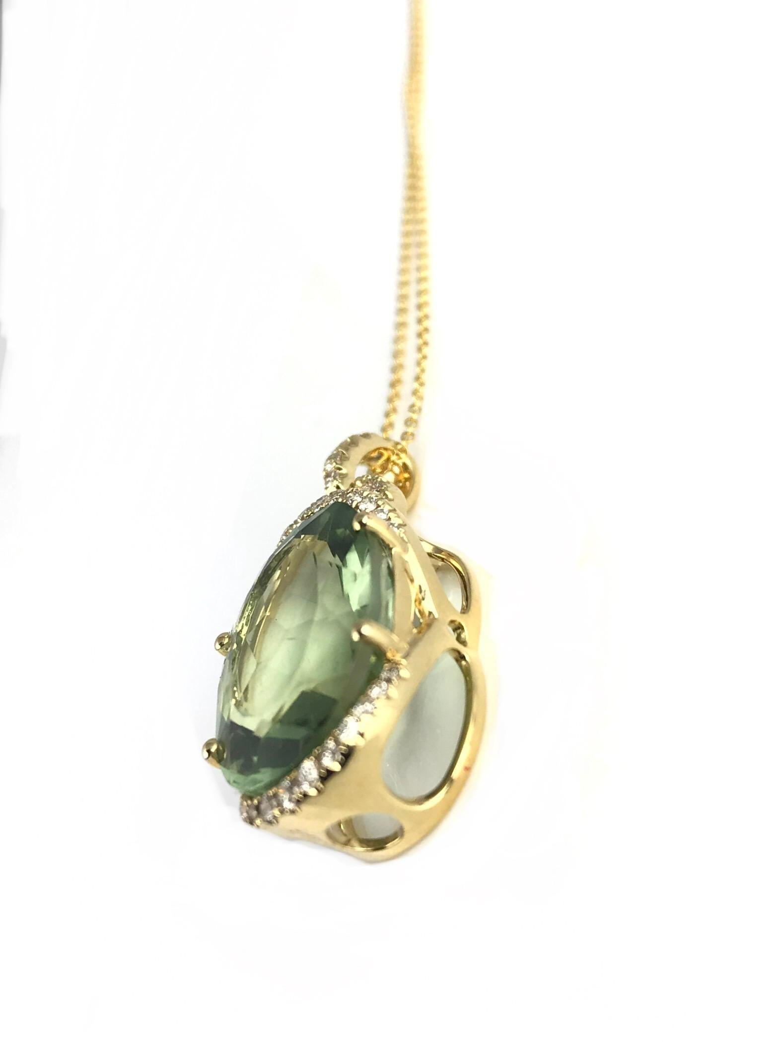 (DiamondTown) This beautiful pendant features a 10.63 carat oval cut exotic green amethyst center, decorated at top and bottom by a curve of round white diamonds. Additional diamonds on the bail bring the total diamond weight to 0.36 carats.

Item