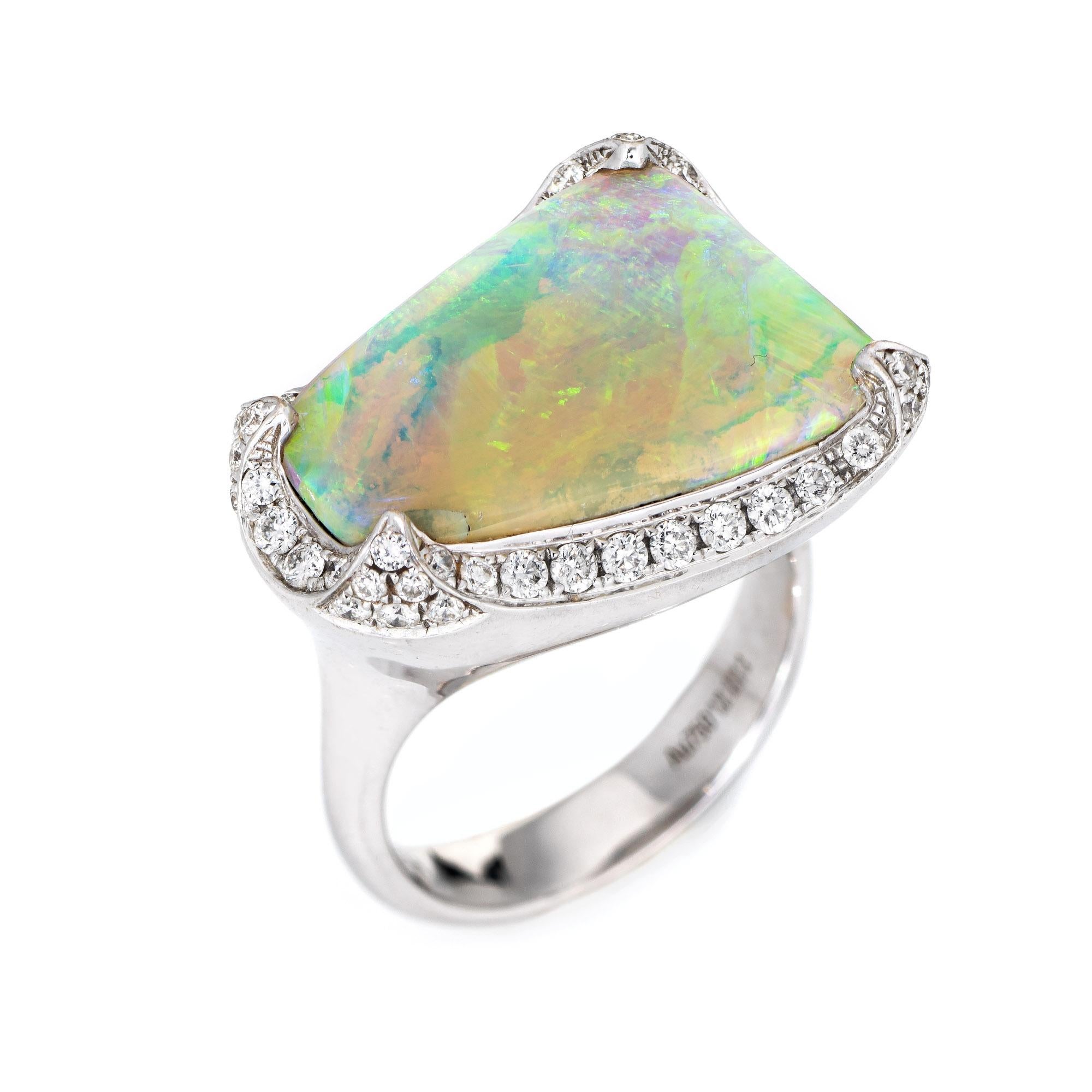 Stylish contemporary opal & diamond cocktail ring (circa 2000s) crafted in 18 karat white gold. 

Natural opal measures 19mm x 14mm (estimated at 10.64 carats) is accented with an estimated 0.85 carats of diamonds (estimated at H-I color and VS2-SI1