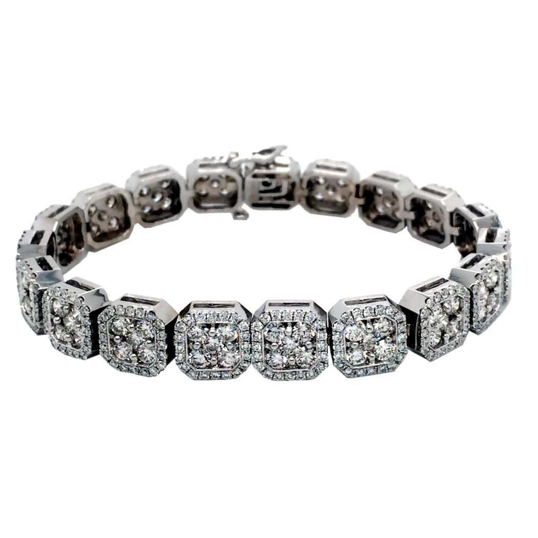 This beautiful Diamond Tennis Bracelet is made in 14K White Gold and consists of 19 Links of Square Pave Set Clusters within a halo. Each square size is equivalent to a 1.5 Ct diamond creating the look of a 22-25 Ct bracelet. 
Available in White,