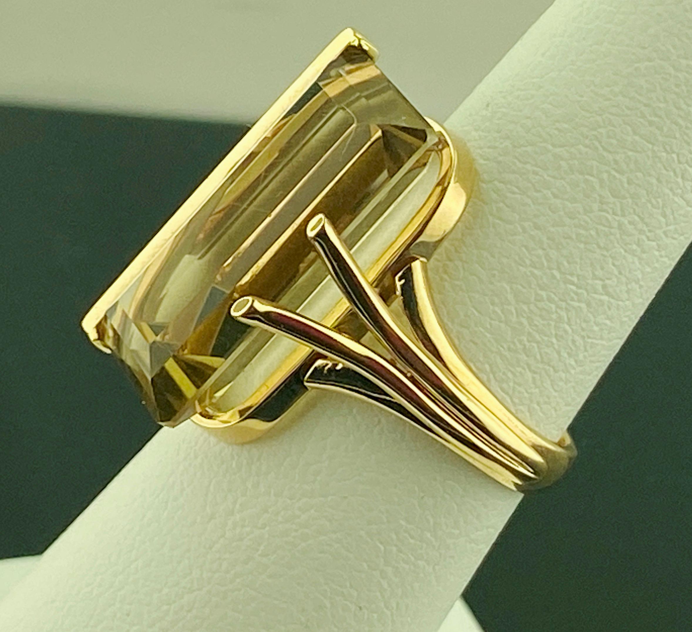 Set in 14 karat yellow gold, weighing 8.18 grams, is one 10.66 carat Emerald cut Smokey Quartz stone  Ring size is 5.75.