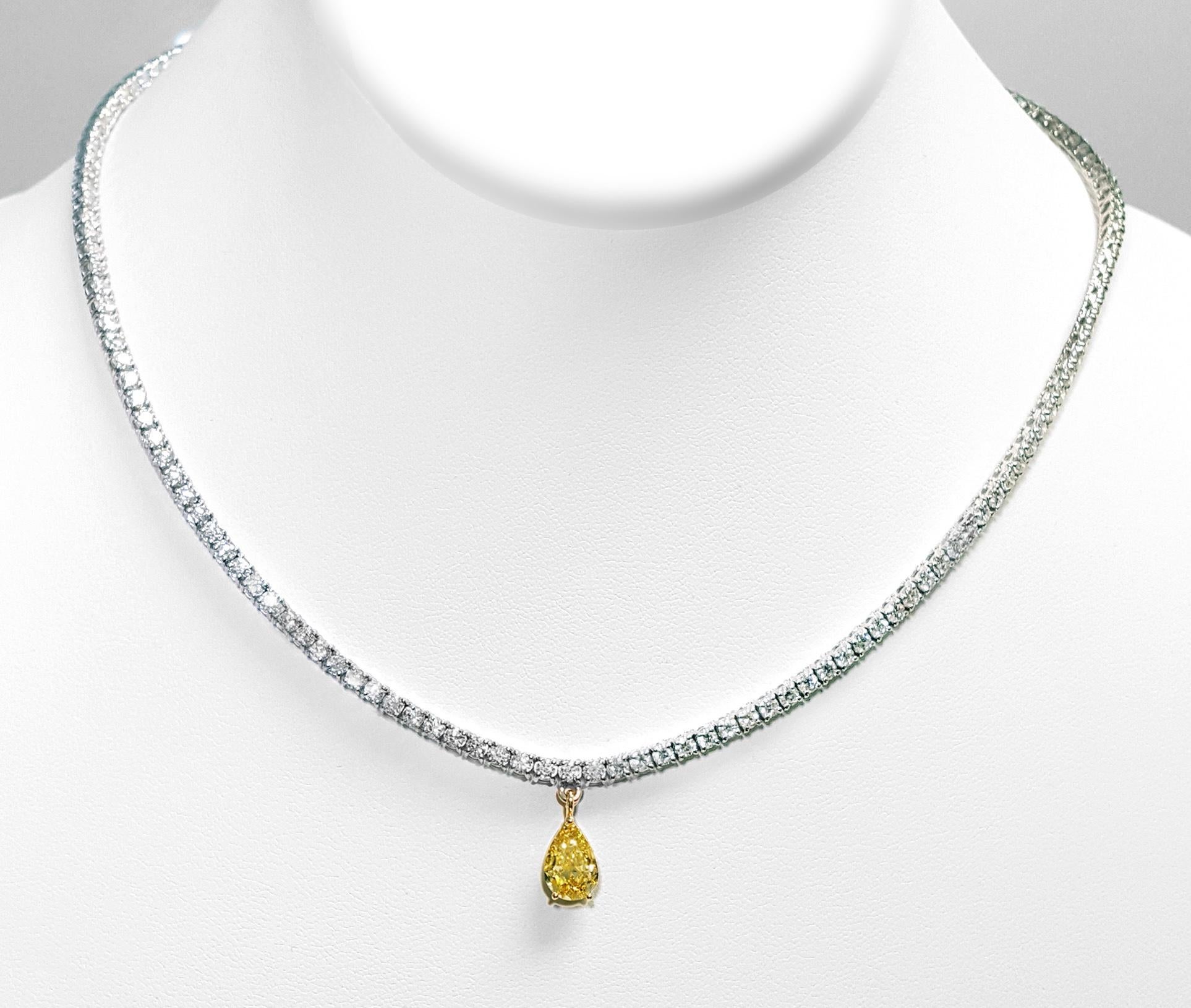 Exquisitely crafted with meticulous attention to detail, this classic 10.66-carat diamond tennis necklace features a distinctive touch: a 1.51-carat Fancy Intense Yellow pear-shaped diamond, GIA certified as VS2 clarity, gracefully suspended at its