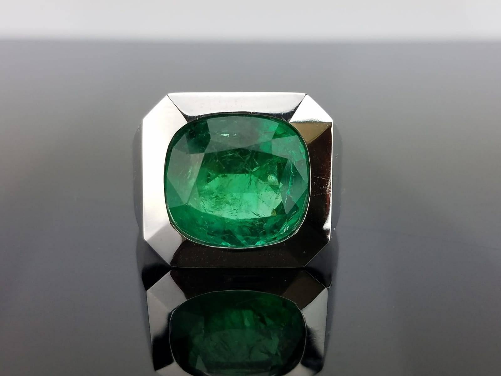 A simple Zambian Emerald set in 18 K white gold band, making it a classic looking men's ring.  

Stone Details:  
Stone: Zambian Emerald 
Carat Weight: 10.67 Carats  

18K Gold:  11.92 grams   

Currently a ring size US 8, but we can resize the ring