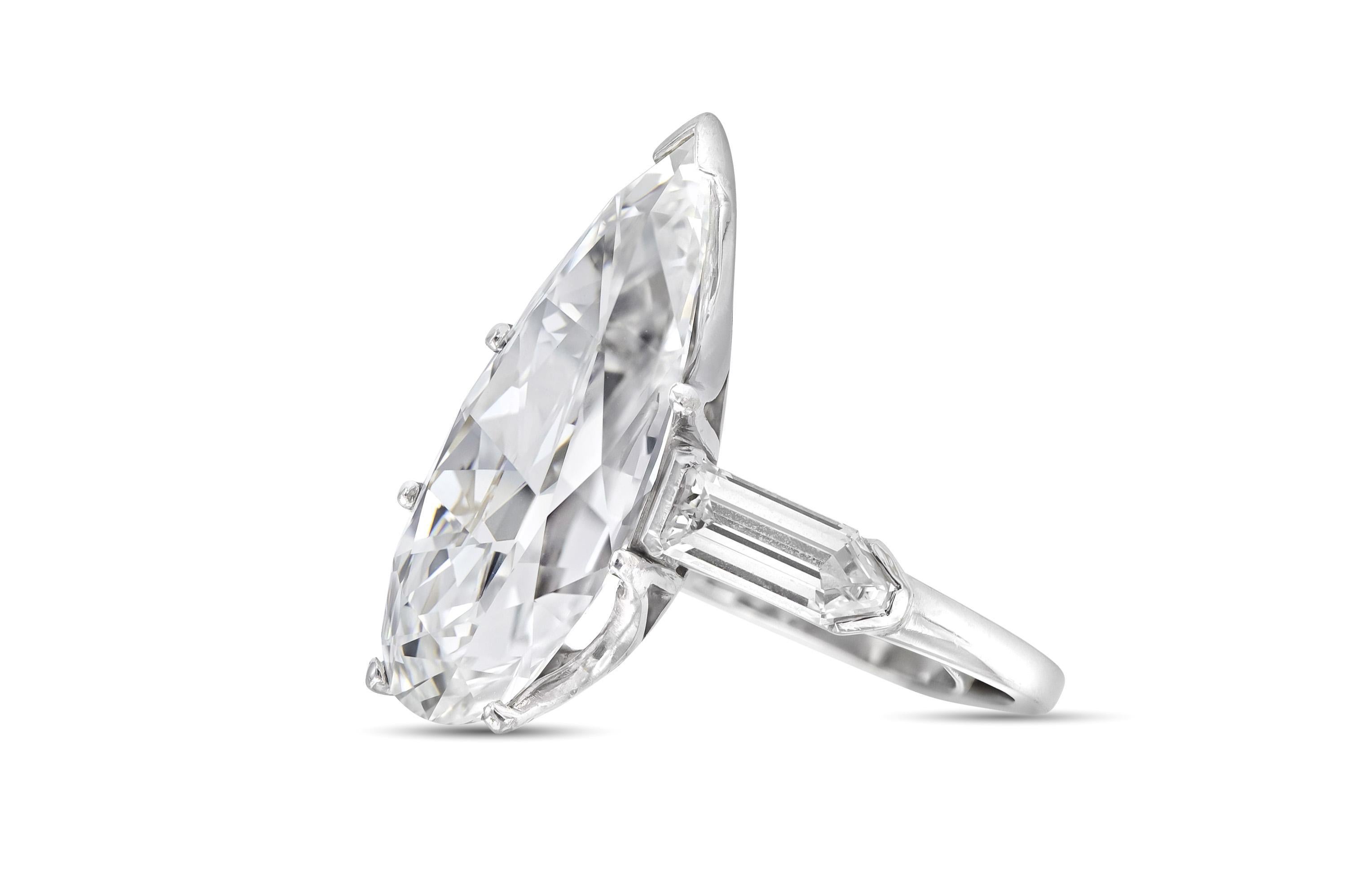Finely crafted in platinum with a GIA certified Pear-Shaped Diamond weighing 10.67 carats, G color, VS1 clarity, GIA #1226180588.
The ring features 2 accenting Shield cut Diamonds.
Size 7, has a guard, resizable