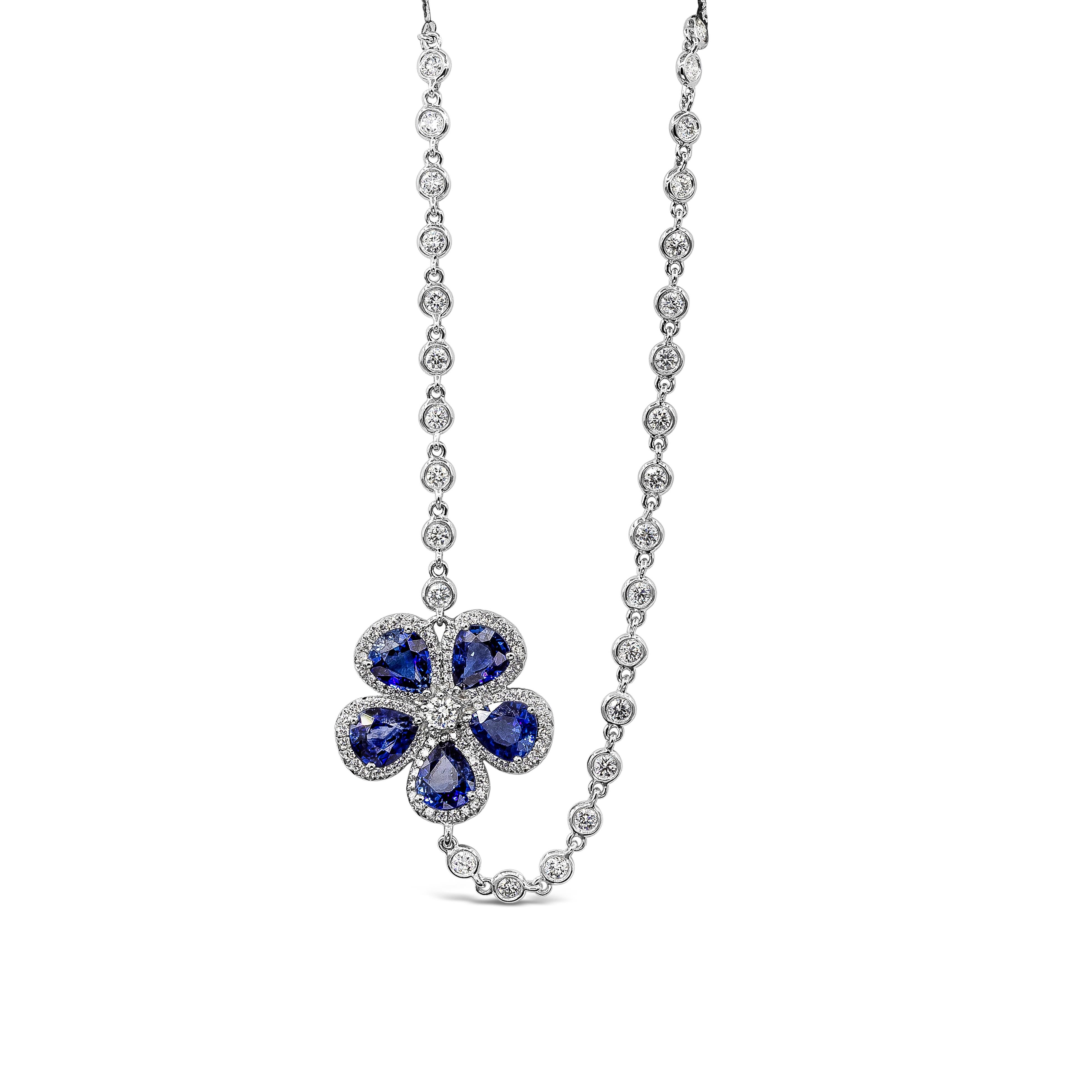 A fashionable and beautiful long necklace showcasing a row of bezel set round diamonds weighing 4.76 carats total. Accented with a flower made of pear shape blue sapphires, finished with brilliant diamond edges. Sapphires weigh 5.89 carats total.
