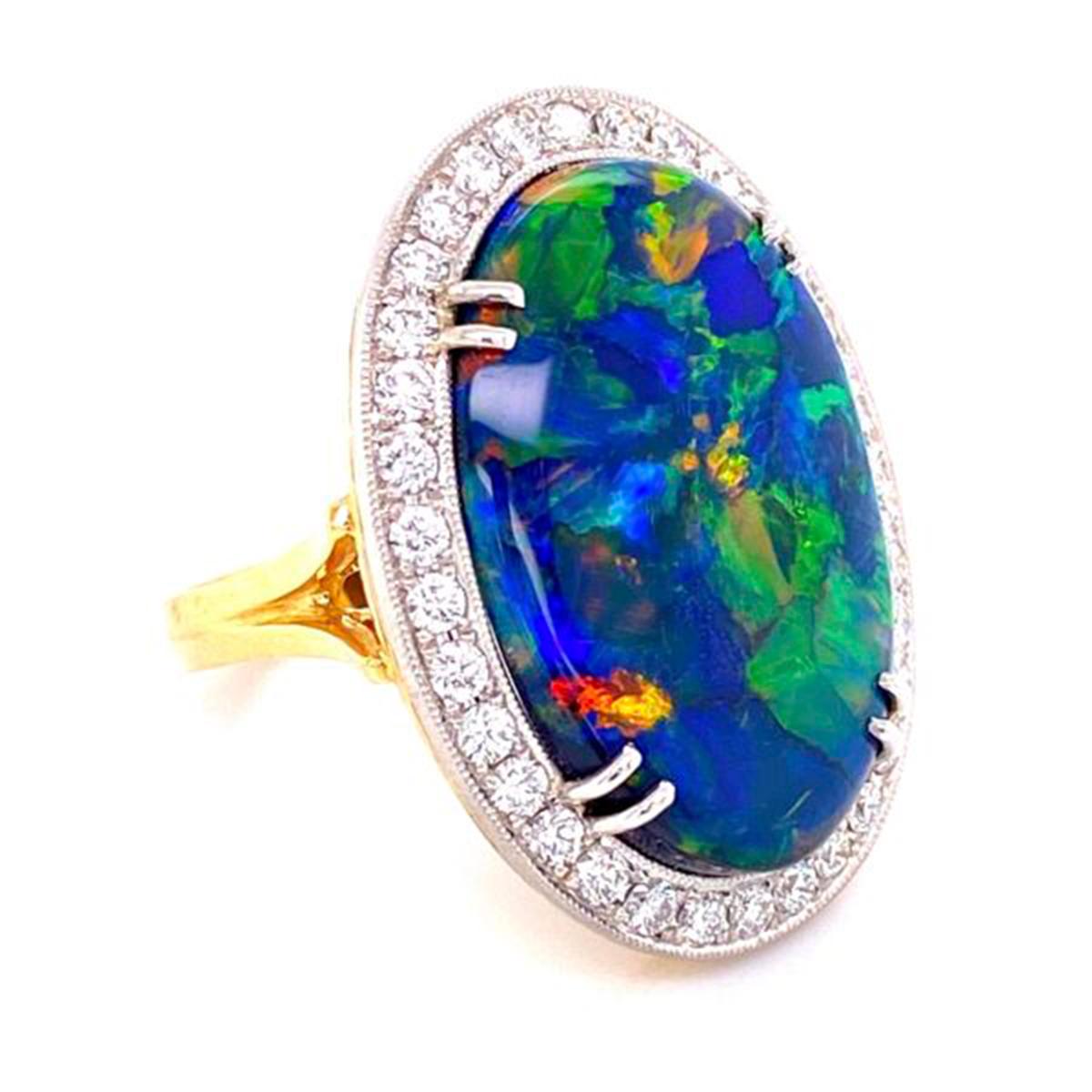 Simply Beautiful! Elegant and finely detailed Solitaire Cocktail Engagement Ring, set with a securely nestled 10.68 Carat Black Opal surrounded by Brilliant-cut Diamonds, weighing approx. 0.82 total Carat weight.  Hand crafted in Platinum on 18