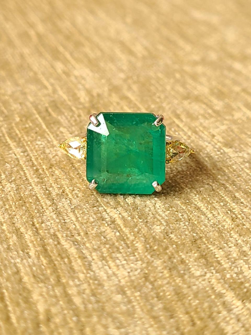 A very gorgeous and one of a kind, Emerald Cocktail/ Engagement Ring set in 18K Gold & Diamonds. The weight of the Emerald is 10.68 carats. The Emerald is completely natural, without any treatment and is of Zambian origin. The combined weight of the