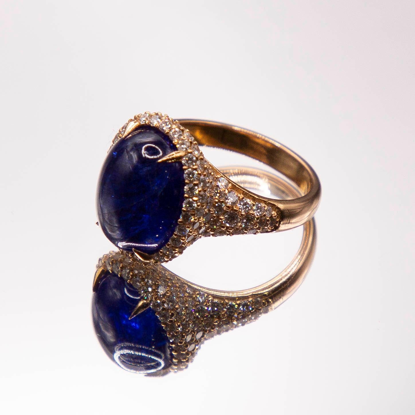 A rare, intense, beautifully translucent purplish- blue 10.69 carats Tanzanite, expertly cut encabachon, sets securely in hand drawn, talon- style prongs. Impeccable, classic, superb- this traditional European styled ring is a one of a kind, created