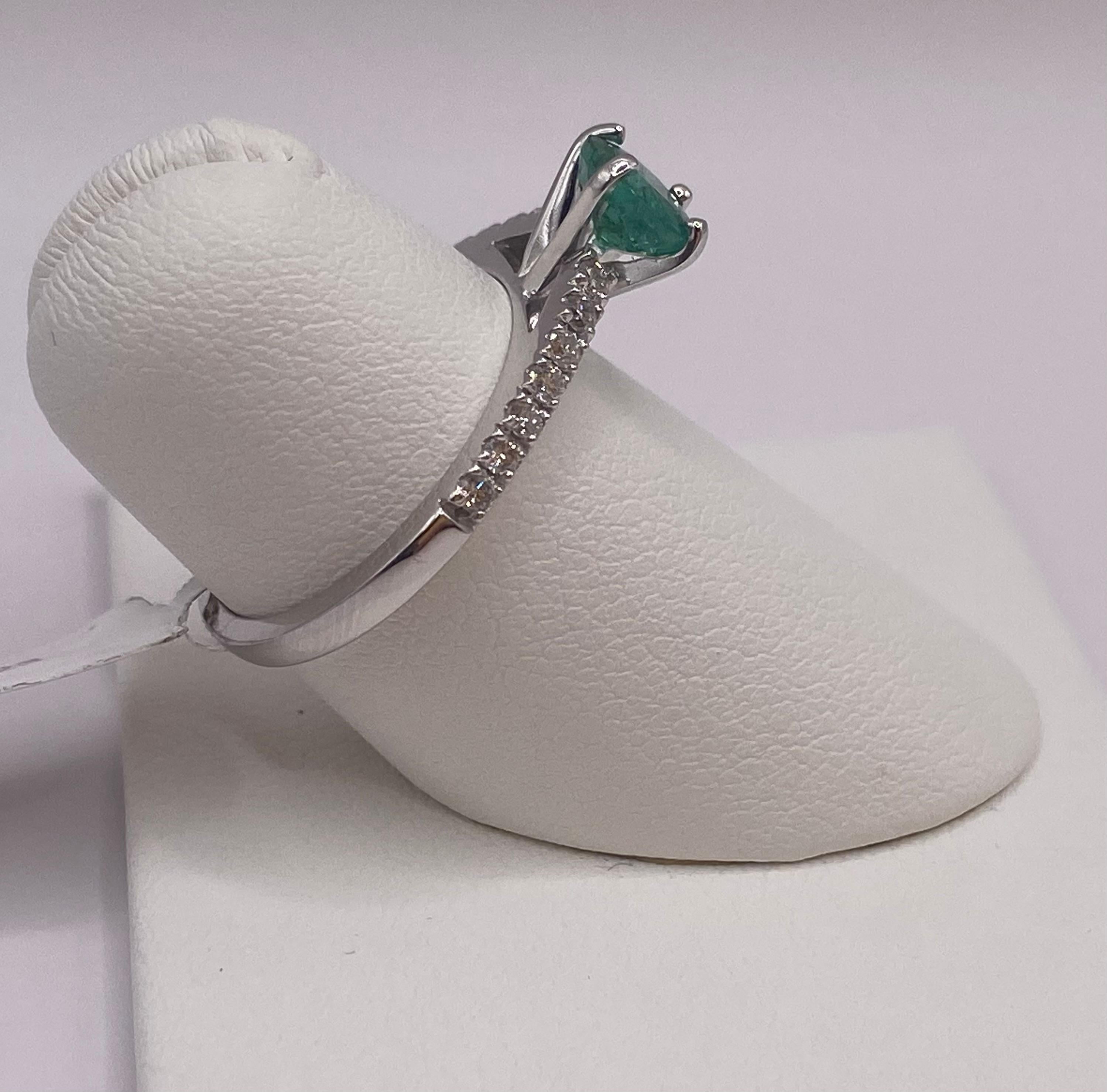 Metal: 14KT White Gold
Ring Size: 6.50
(Ring is size 6.5, but is sizable upon request)

Number of Round Emeralds: 1
Carat Weight: 0.83ctw
Stone Size: 6.0mm

Number of Round Diamonds: 14
Carat Weight: 0.23ctw