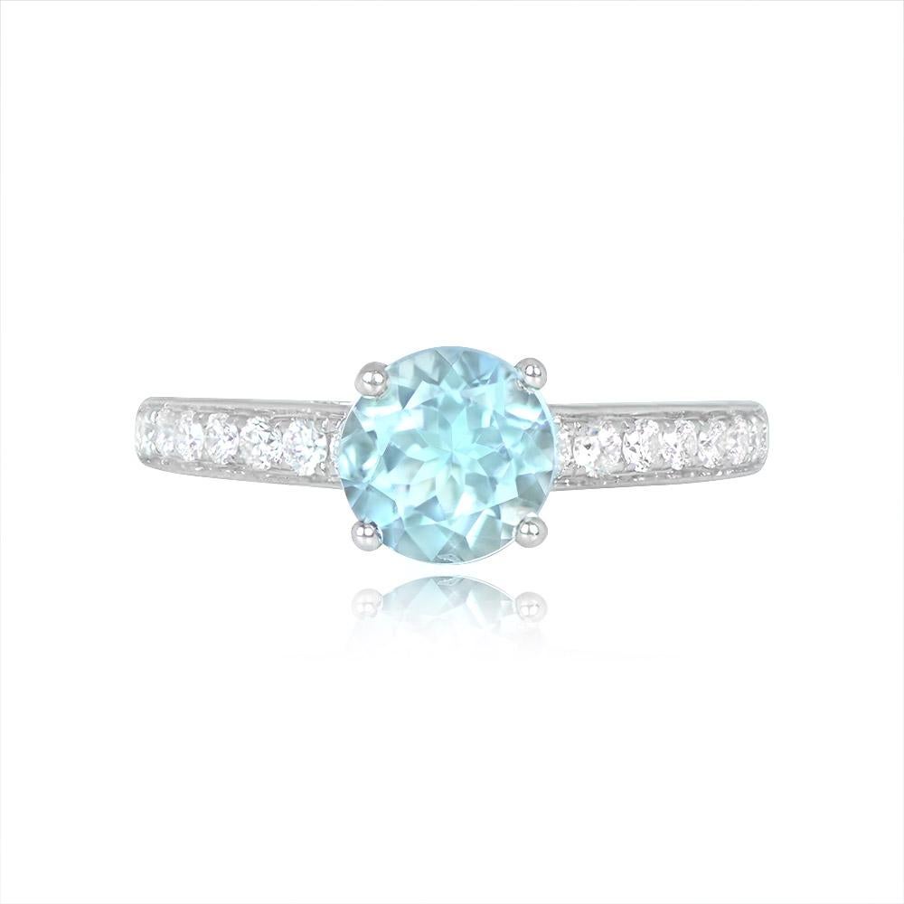 This engagement ring features a 1.06-carat round-cut aquamarine held by prongs. The shoulders are adorned with around 0.24 carats of round brilliant cut diamonds. The ring is meticulously handcrafted in 18k white gold.


Ring Size: 6.5 US,