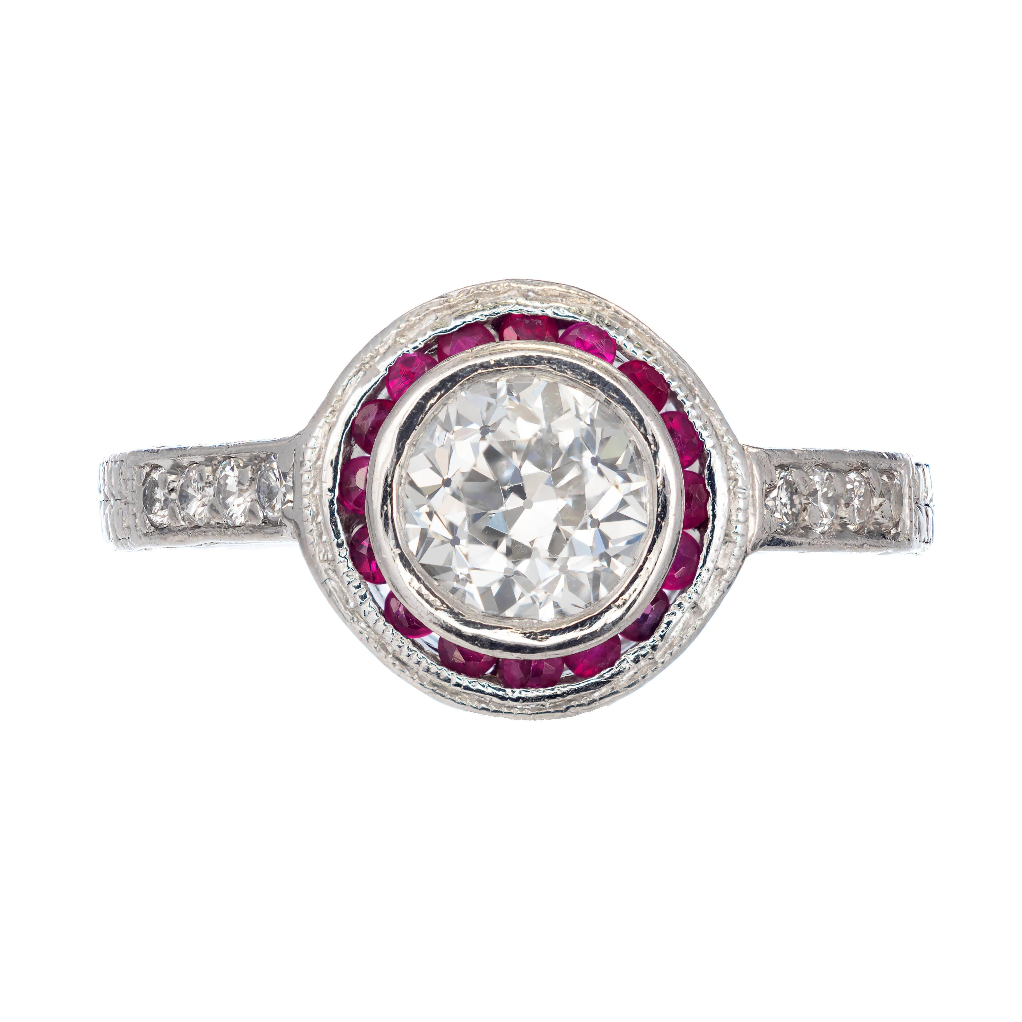 EGL certified diamond and ruby halo engagement ring. 1.07ct round center diamond in a Platinum setting with a halo of genuine round rubies. Raised crown and small table graded by the good polish and good symmetry. The shoulders are bead set with 8