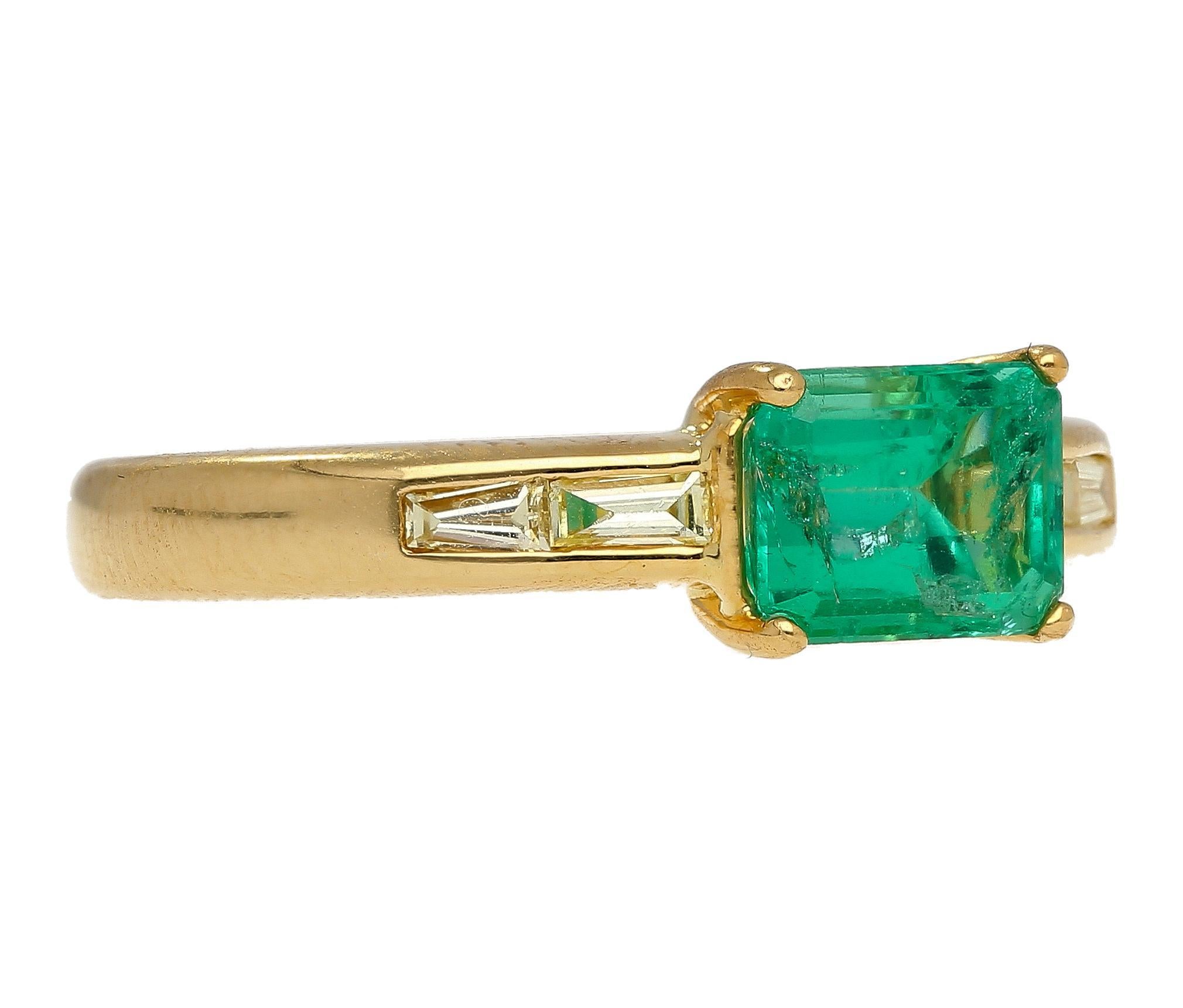 This 18K yellow gold east west ring features a 1.07 carat emerald cut emrald paired with 0.19 carat baguette-cut diamonds for a sleek, timeless look. Ring size 6.5, adjustable.

Details:
Item Type: East West Ring
Metal: 18K Yellow Gold
Weight: 4.21