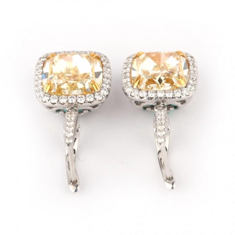 Clarity: SI2
Earring Style: Drop
Metal: 18kt White Gold
Center Stone: Fancy Yellow Diamond
Center Diamond Weight: 10.7ctw
Stone Shape: Cushion Cut
Total White Diamond Carat Weight: 0.83
Comes with GIA Certificate for both diamonds.