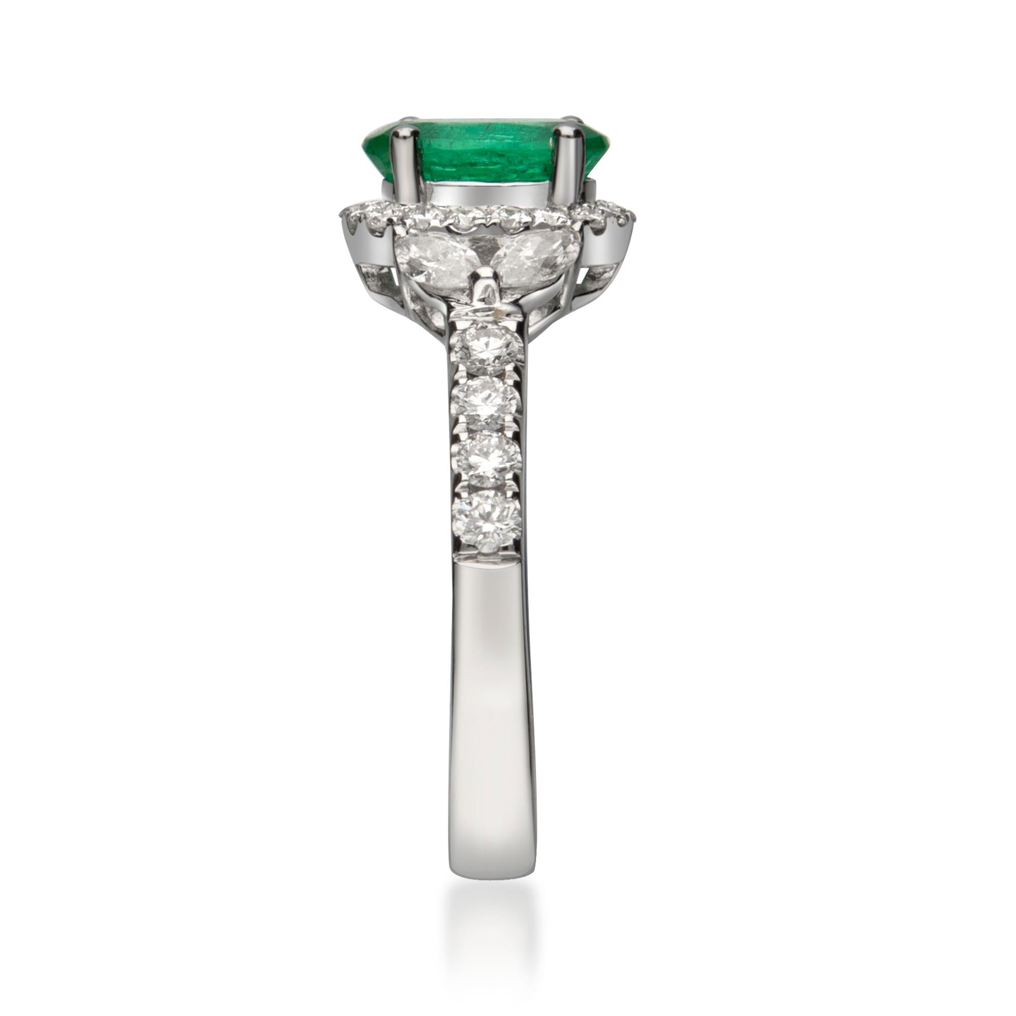 This beautiful Emerald Ring is crafted in 14-karat White gold and features a 1.07 carat 1 Pc Natural Emerald, 26 Pcs Round White Diamonds in GH- I1 quality with 0.40 Ct and 4 Pcs Marquise White Diamonds in GH- I1 quality with 0.31 Ct  in a