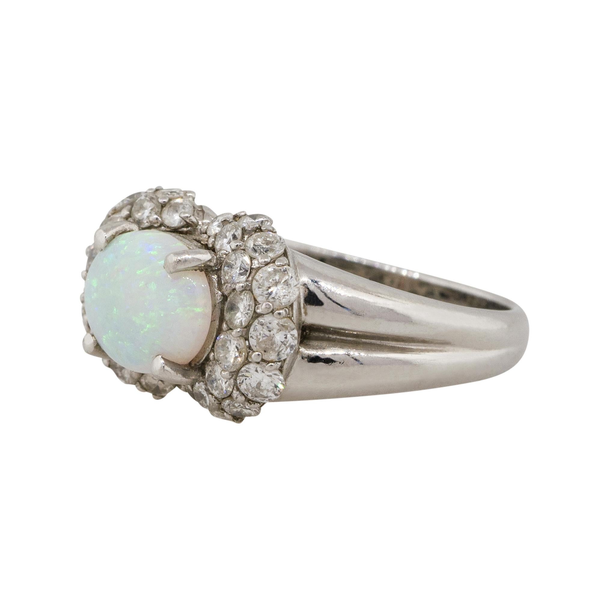 Material: Platinum
Gemstone details: Approx. 1.07ctw Oval shaped Opal center gemstone
Diamond details: Approx. 0.95ctw of Round cut Diamonds. Diamonds are G/H in color and VS in clarity
Ring Size: 6 
Ring Measurements: 0.75