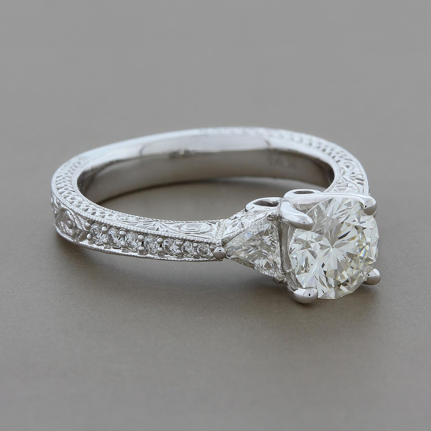 This classic engagement ring features a 1.07 carat round cut GIA Certified diamond with J color and VVS2 clarity. Accenting the center diamond are 0.36 carats of trillion cut diamonds on the shoulders with round cut diamonds on the shank. The