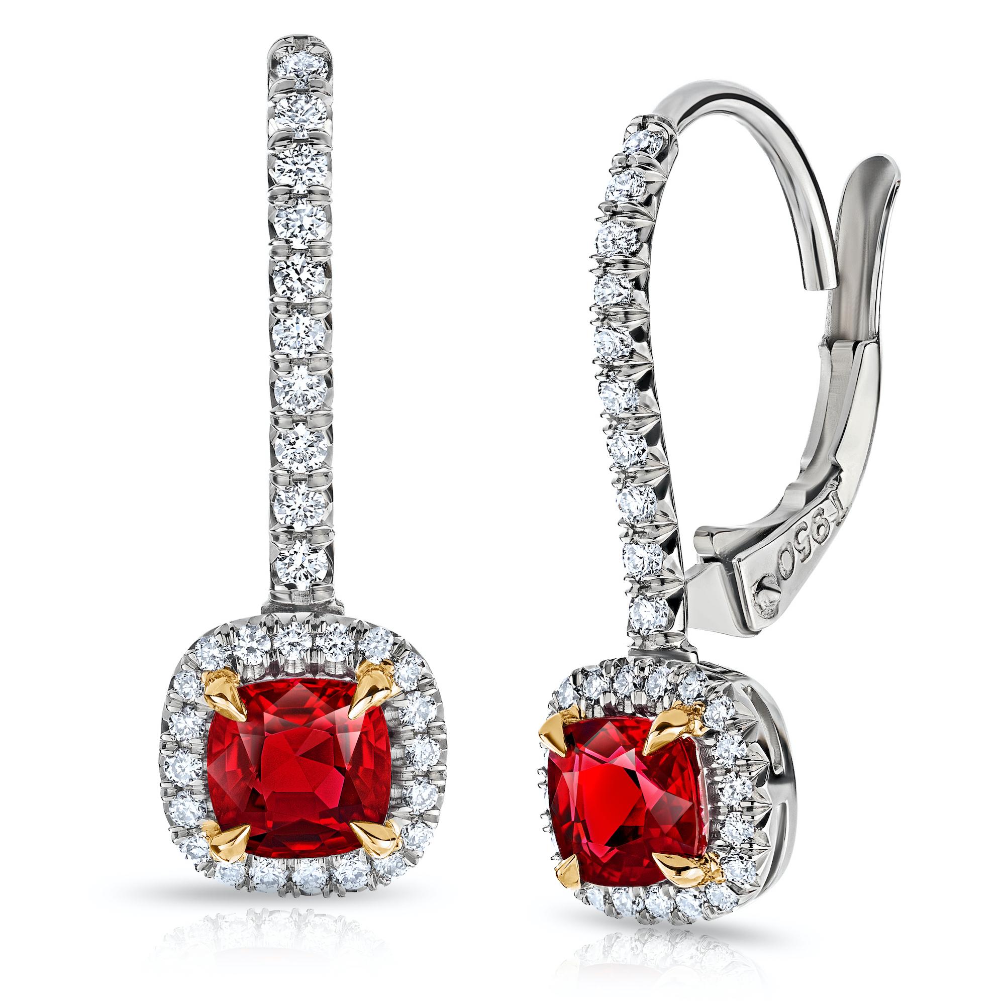 Ruby and diamond halo earrings with a total Ruby weight of 1.07 carats and total diamond weight of 0.26 carats set on platinum and 18k yellow gold lever backs