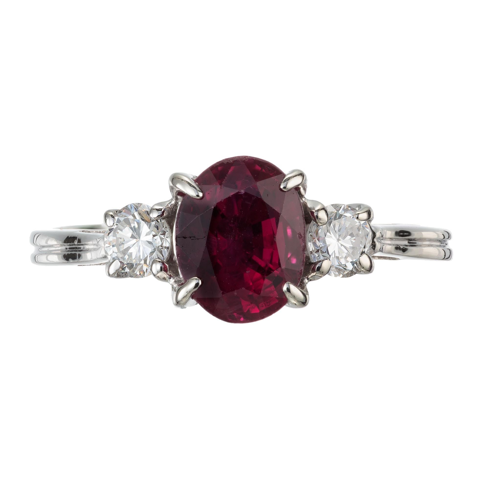 Natural simple heat Ruby and diamond ring. Oval center ruby with two round side diamonds in a classic three-stone 14k white gold setting. AGL certified.   

1 bright red oval Ruby, approx. 1.07cts AGL certificate #GB51731
2 brilliant cut diamonds,