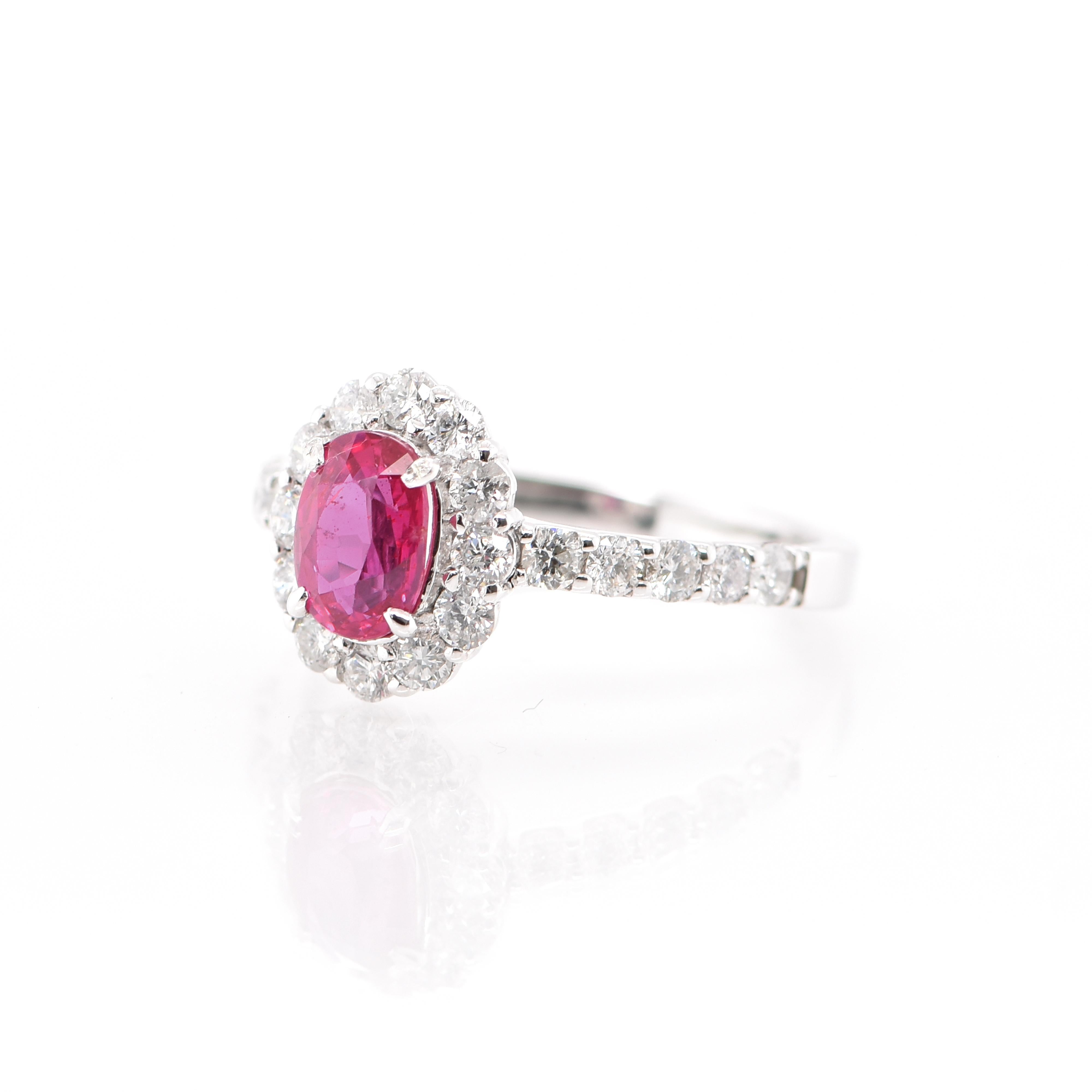 A beautiful Halo Engagement Ring featuring a 1.07 Carat No Heat (Untreated) Ruby and 0.77 Carats of Diamond Accents set in Platinum. Rubies are referred to as 