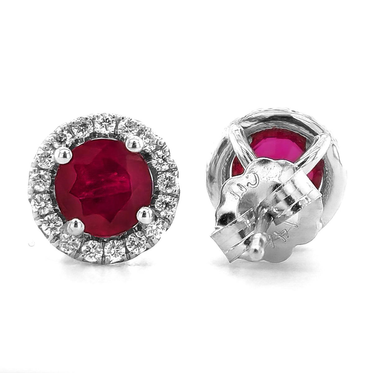 Redefine elegance with these stunning 14K white gold stud earrings, finely crafted in a rich shine. Round cut natural rubies secured in classic four-prong settings nestle in the center, displaying a rich red. Sparkling round brilliant cut diamonds
