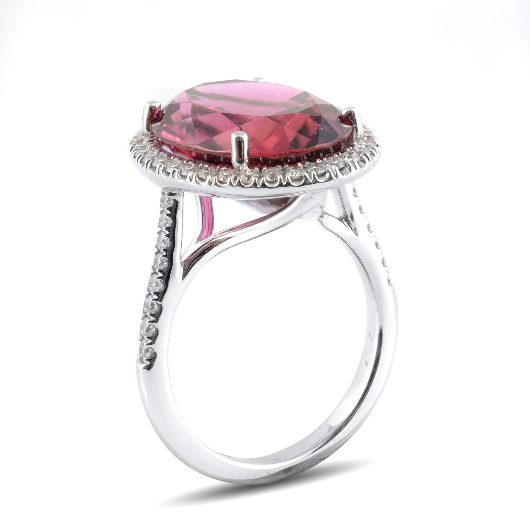 Rubellite’s are blessed with intense color and this 10.71 carat gemstone is no different. Rich fuchsia pinks paired with the play of light off each facet, creates an arresting display of color and internal fire. Surrounded by diamonds that add to
