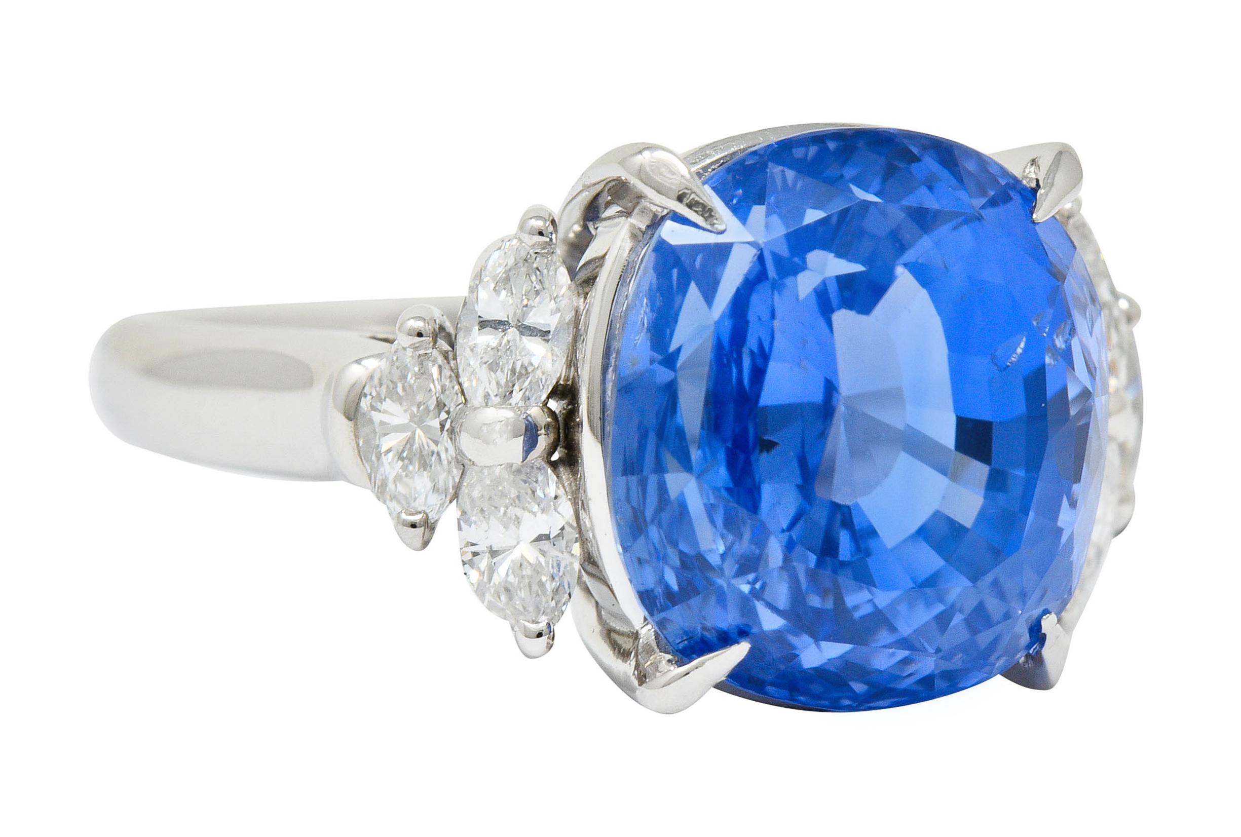 Centering a basket set modified cushion brilliant Ceylon sapphire weighing 10.14 carats

Transparent, cornflower blue, with no indications of heat; Sri Lankan in origin

Flanked by marquise diamond clustered shoulders, weighing in total