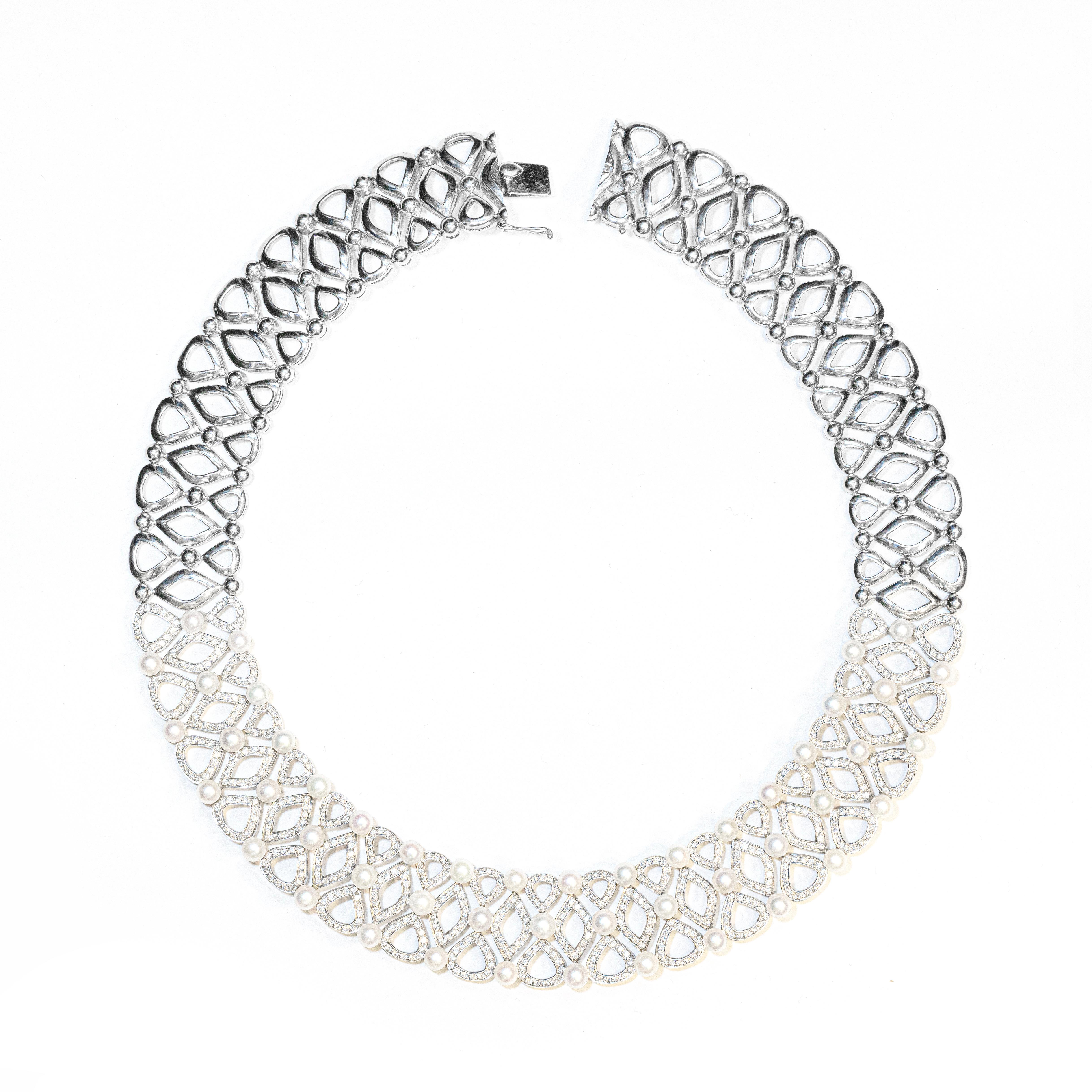 Resplendent and bold, this wonderful 18 carat white gold collar necklace features an intricate open work design beautifully inlaid with round brilliant cut diamonds on its frontal half, weighing 10.72ct in total. Elegant details are added to the