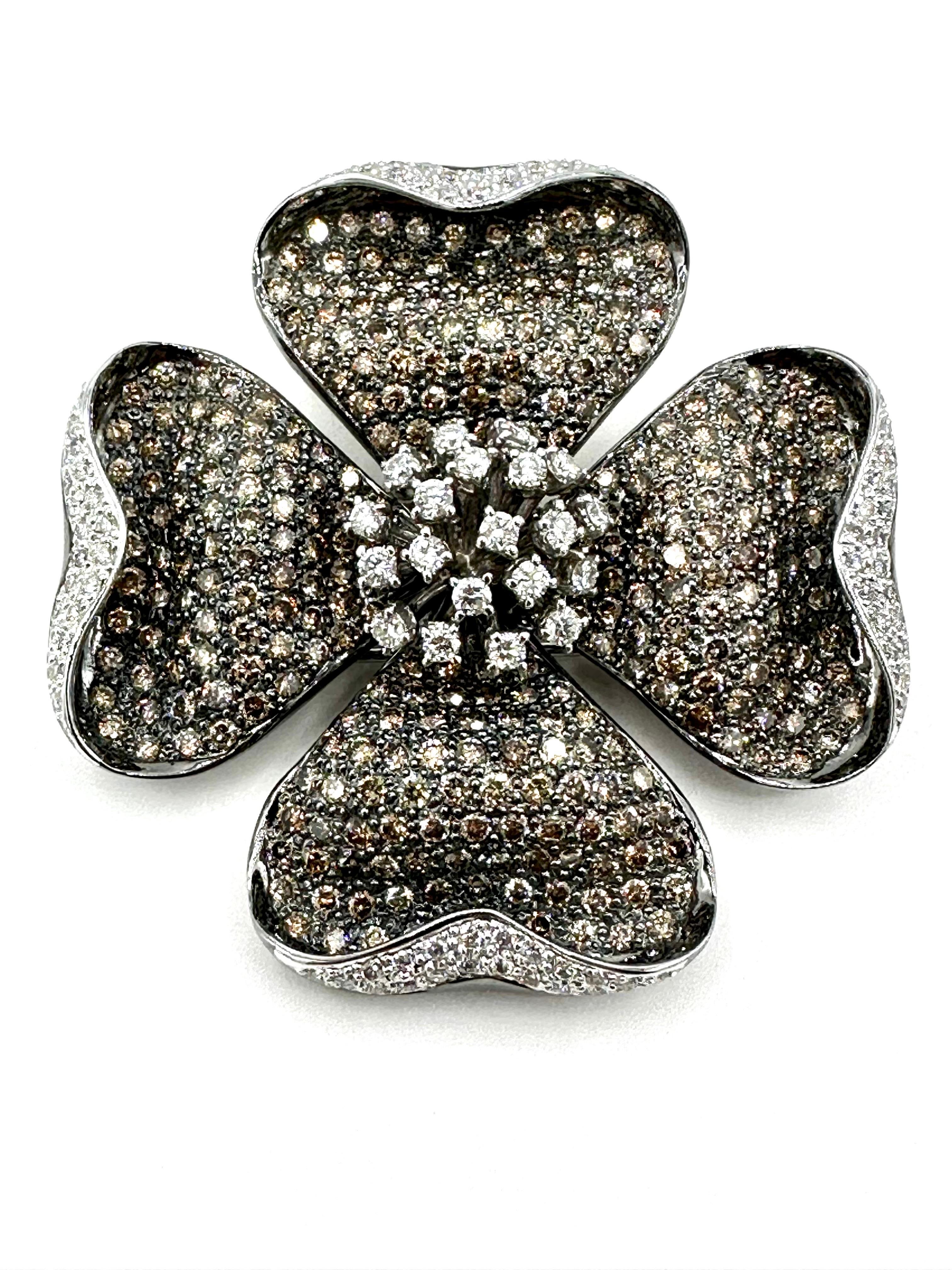 This dogwood brooch is glistening with 343 round brilliant cognac and white Diamonds!  The Diamonds combine for a total weight of 10.72 carats set in 18K white gold.  The brooch features a double pin back with closure, and the back center of the