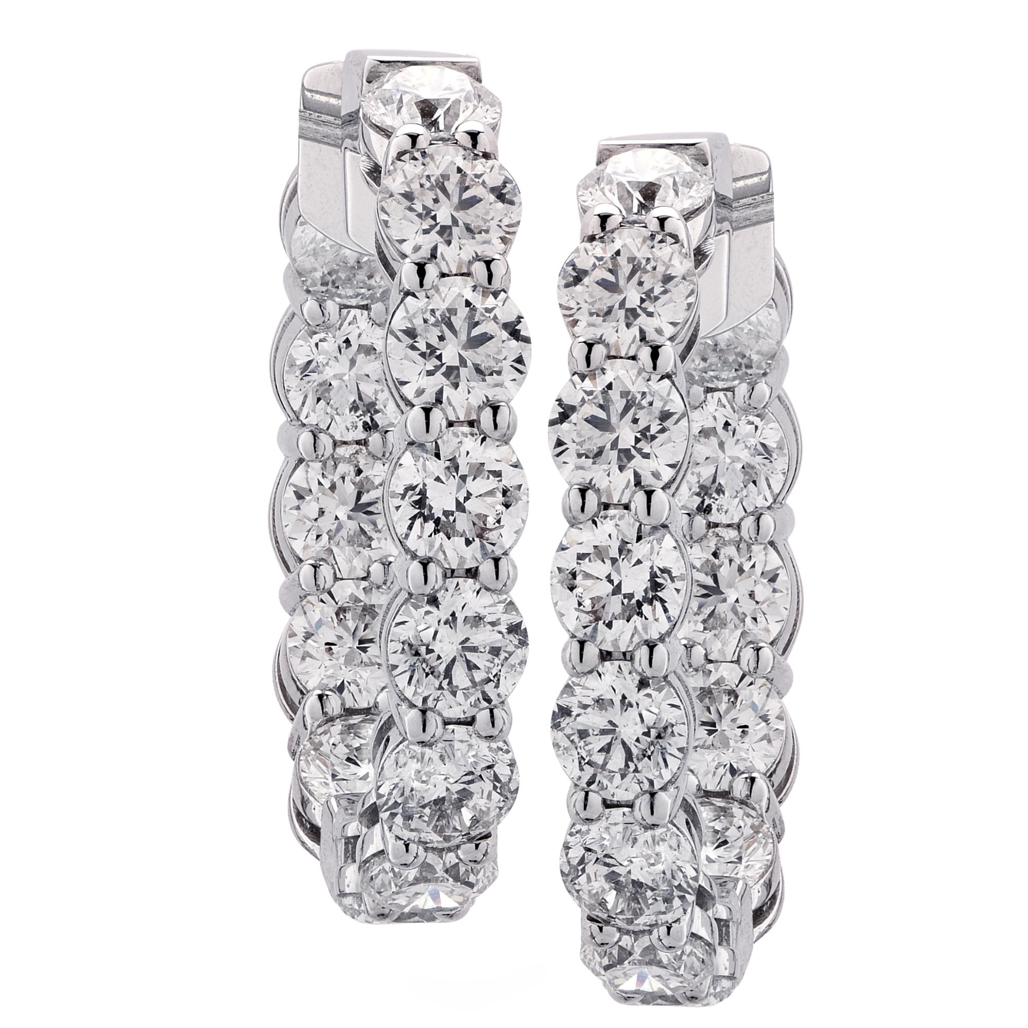Beautiful awe inspiring 18k white gold diamond hoop earrings featuring 26 round brilliant cut diamonds weighing 10.73cts total, H color, VS- SI Clarity. These earrings measure 1.15 inches by 1 inch and measure 4.8mm wide. These magnificently