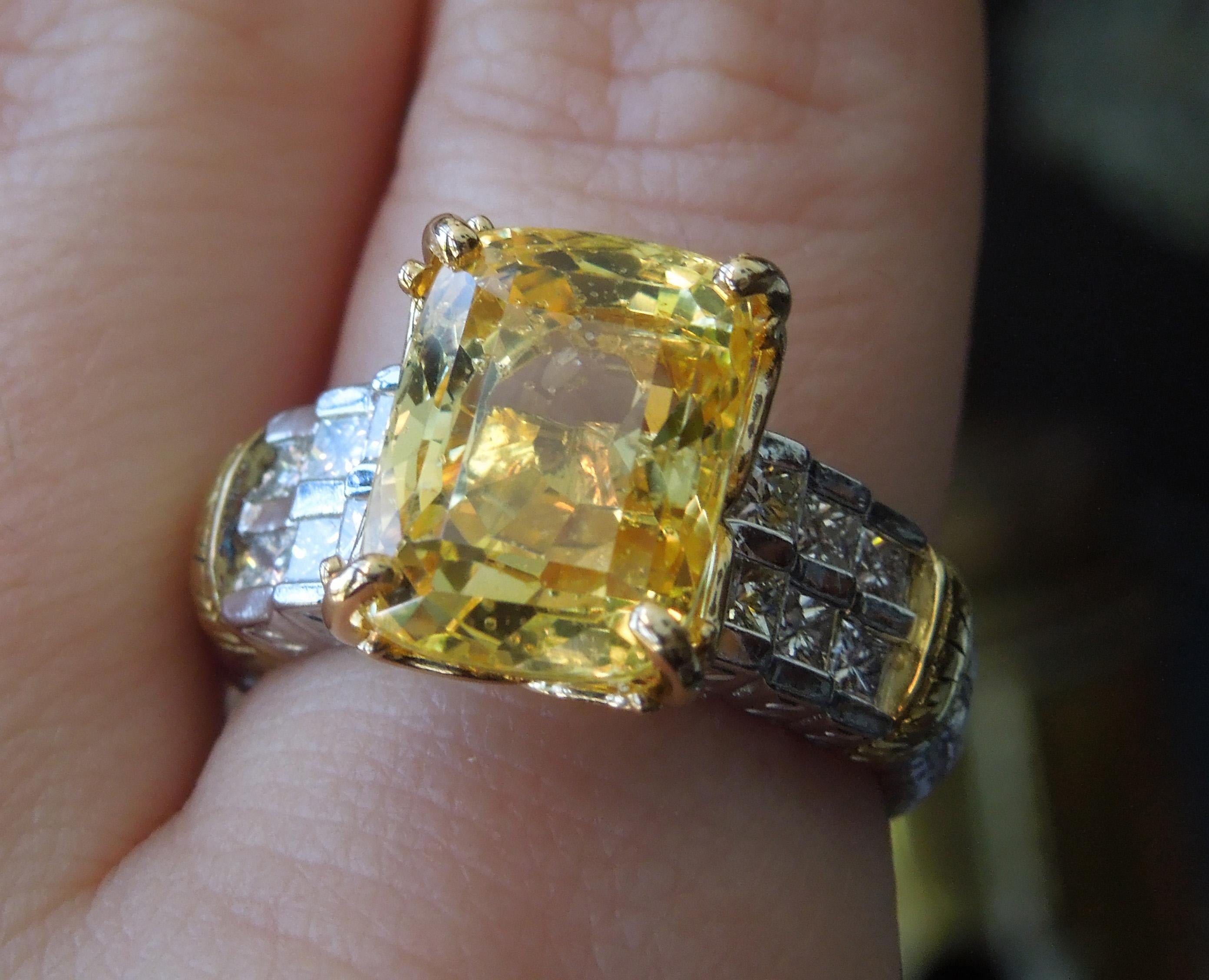 This Sapphire & Diamond Ring from our Beverly Hills Estate Collection features a central GIA Certified 10.75 carat Cushion cut Vivid Yellow Sapphire, securely set in an 18KT Yellow Gold 4-Prong Filigree head. Accented with 12 (6/ea side) Nearly