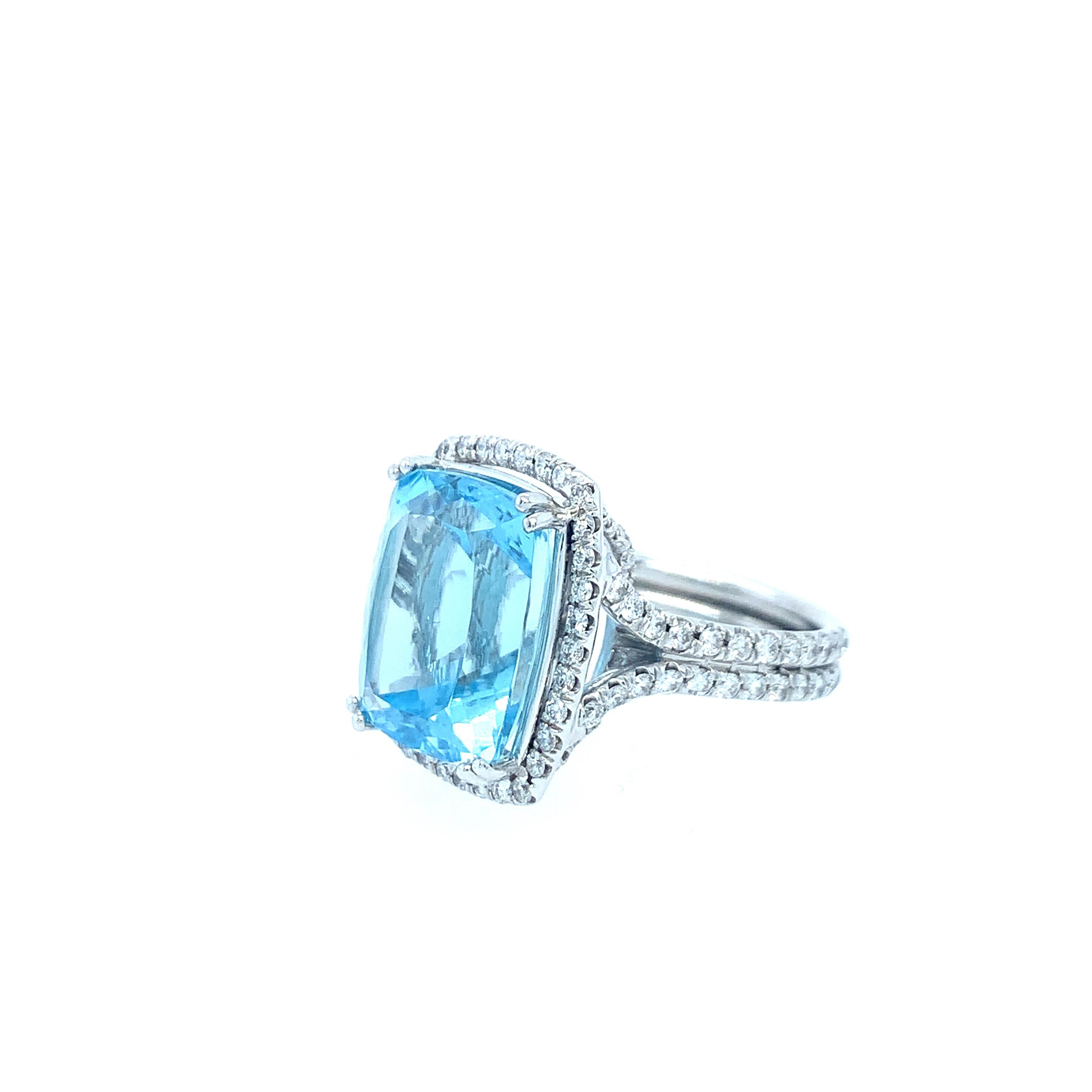 A stunning 10.77ct aquamarine center surrounded by a double halo of diamonds weighing a total of 1.27ct. The center aqua is a cushion cut stone surrounded by round brilliant cut diamonds. The mounting is 18K white gold and contrasts effortlessly