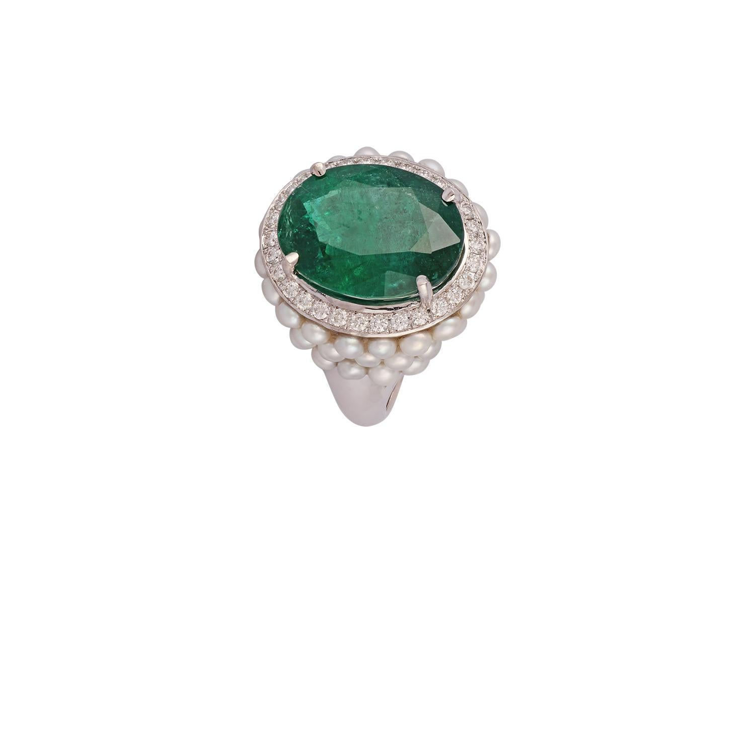 This is an elegant emerald, Pearls & diamond ring studded in 18k white gold with 1 piece of Oval Cut  shaped Zambian emerald weight 10.77 carat which is surrounded by 50 pieces of Pearls weight 4.53 carat & round shaped diamonds weight 0.44 carat,