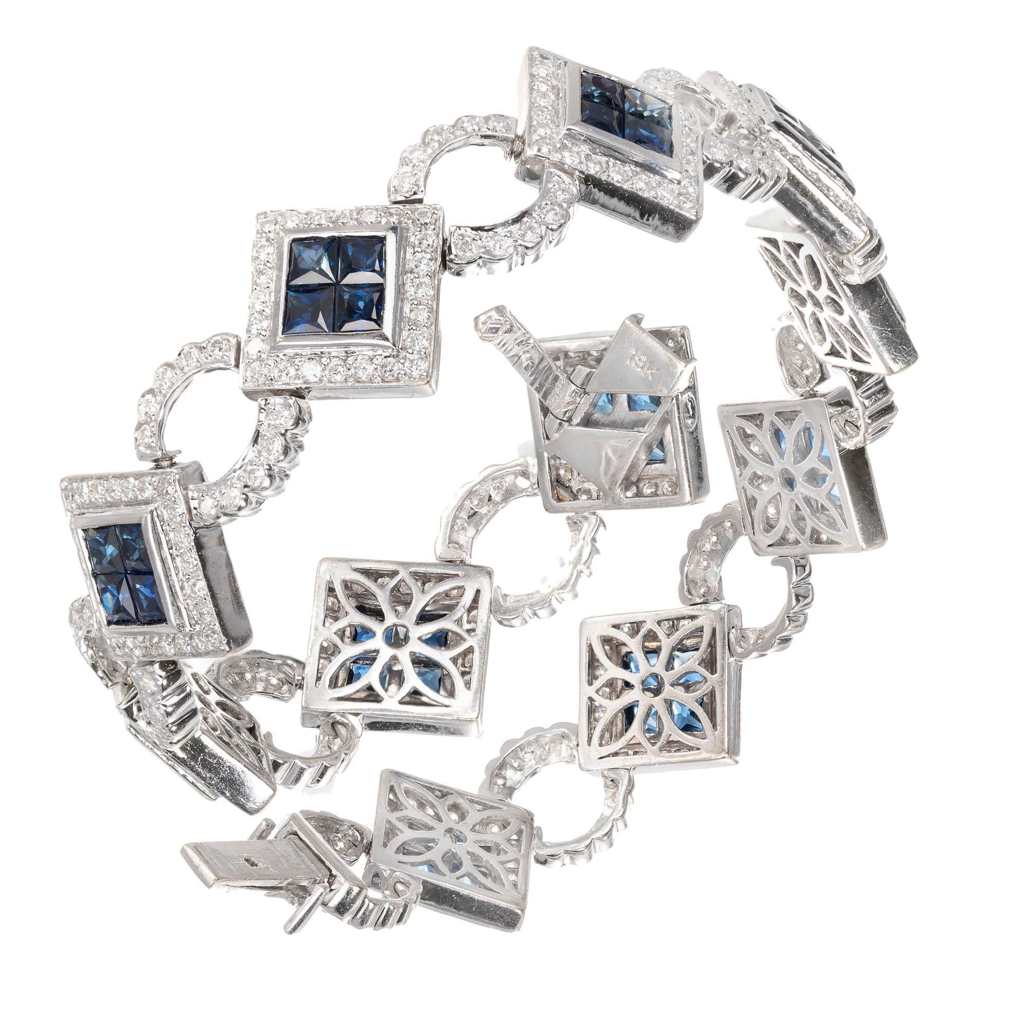 18k white gold blue sapphire and diamond bracelet. Underside safety. Sapphires are invisibly set with round accent diamonds. Hand piercing on the back where it does not show. Length: 7.5 inches 

44 Square sapphires amount to 5.39ct total. 
37 round