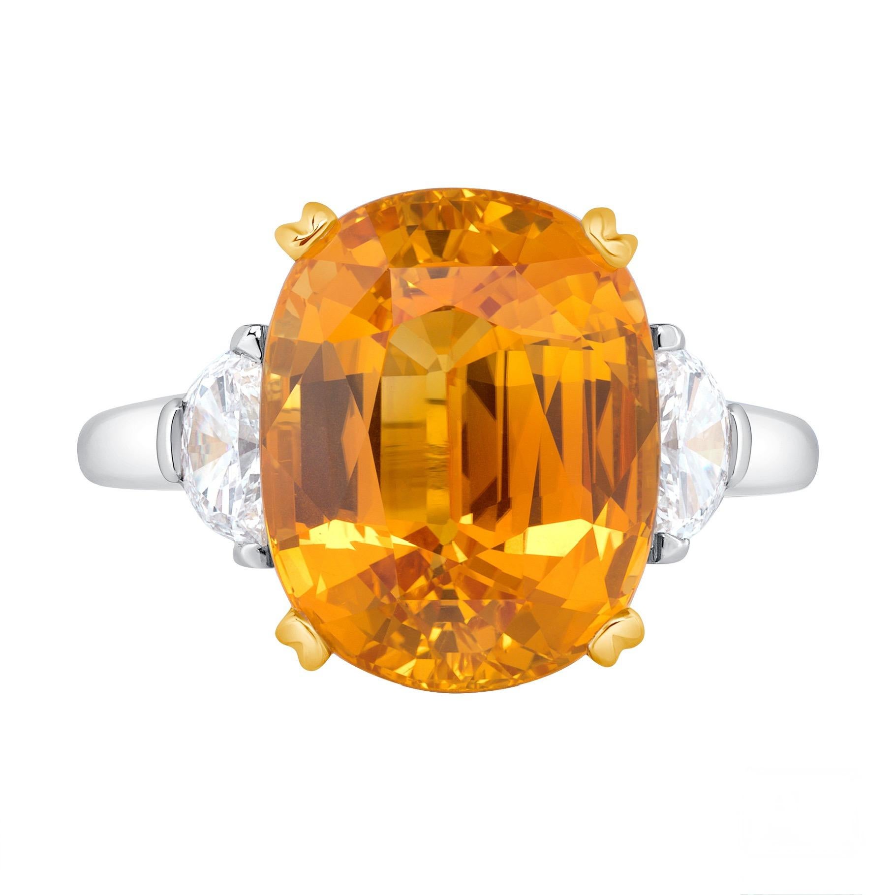 An enriching 10.78-carat honey-yellow sapphire from Sri-Lanka makes a dazzling display in this beauteous ring. The awe-inspiring sapphire is flanked by two half-moon cut diamonds totaling 0.52ct. Fabricated in platinum with 18K yellow gold. The