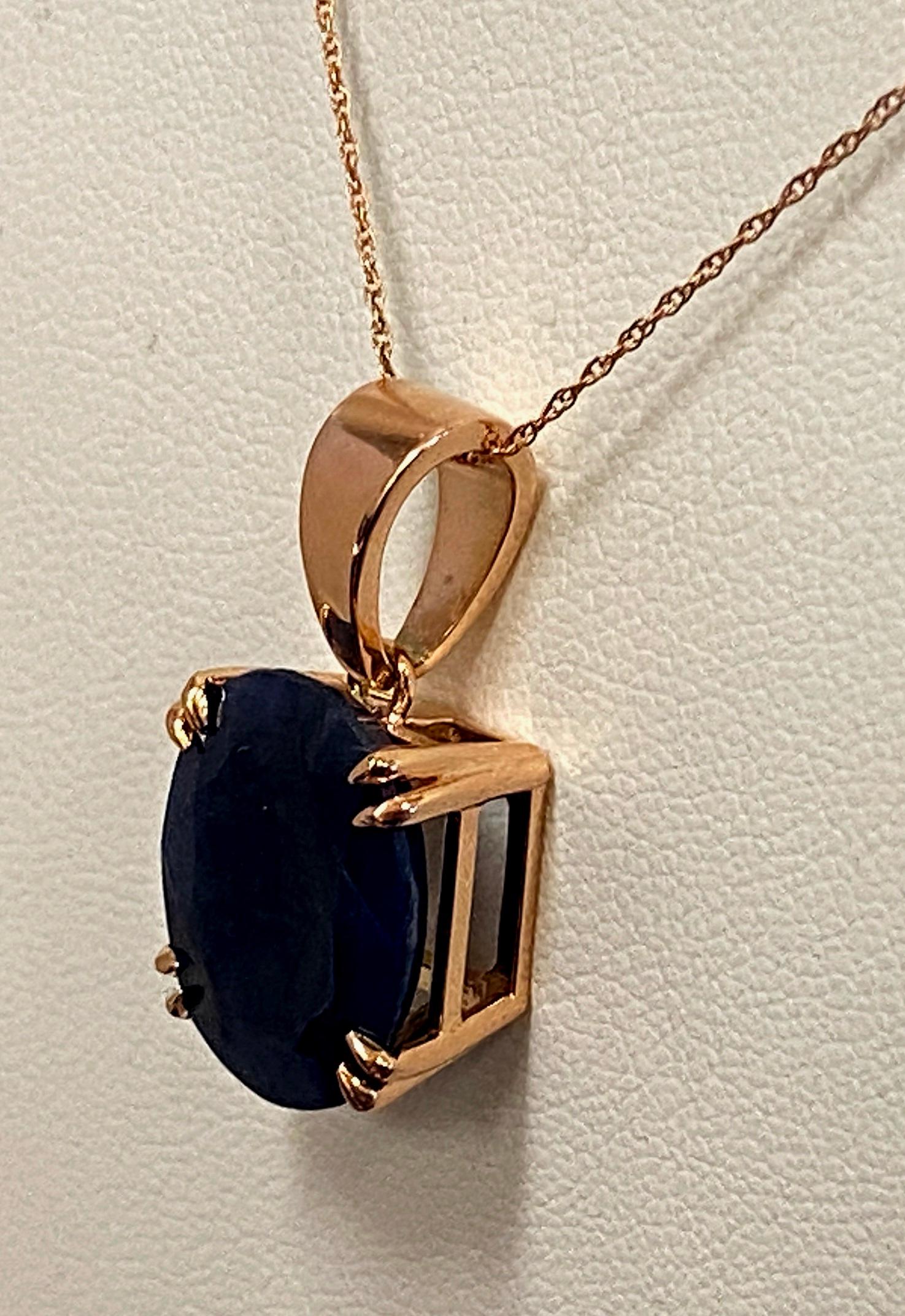 Set in 18 karat Rose Gold is a 10.79 carat Oval cut Blue Sapphire.  Length is 8.5