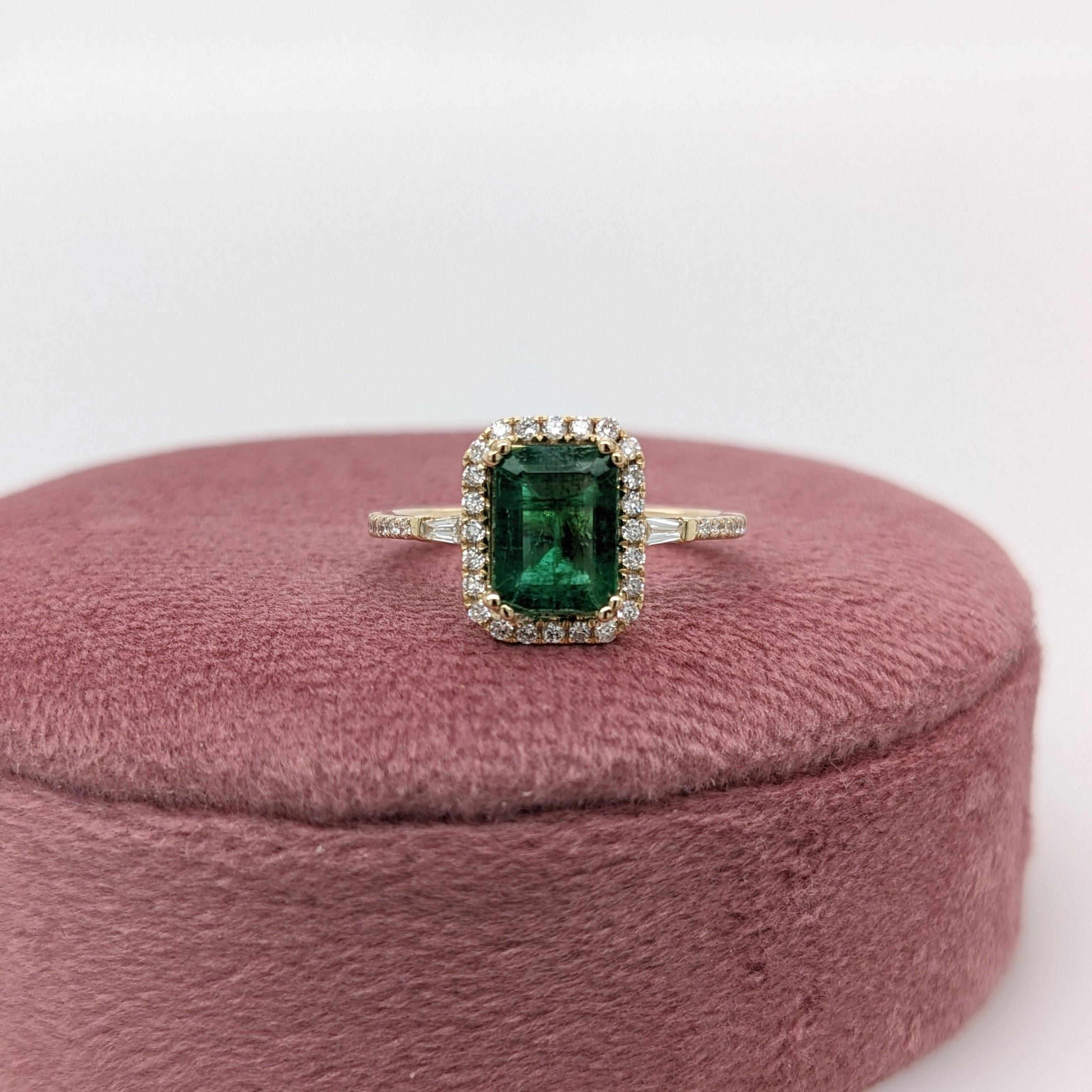 This ring features a beautiful emerald set in a classic NNJ Designs halo ring setting with sparkling natural diamonds all set in 14k solid yellow gold. This design features two tapered baguette diamond accents in the shank. A gorgeous modern look