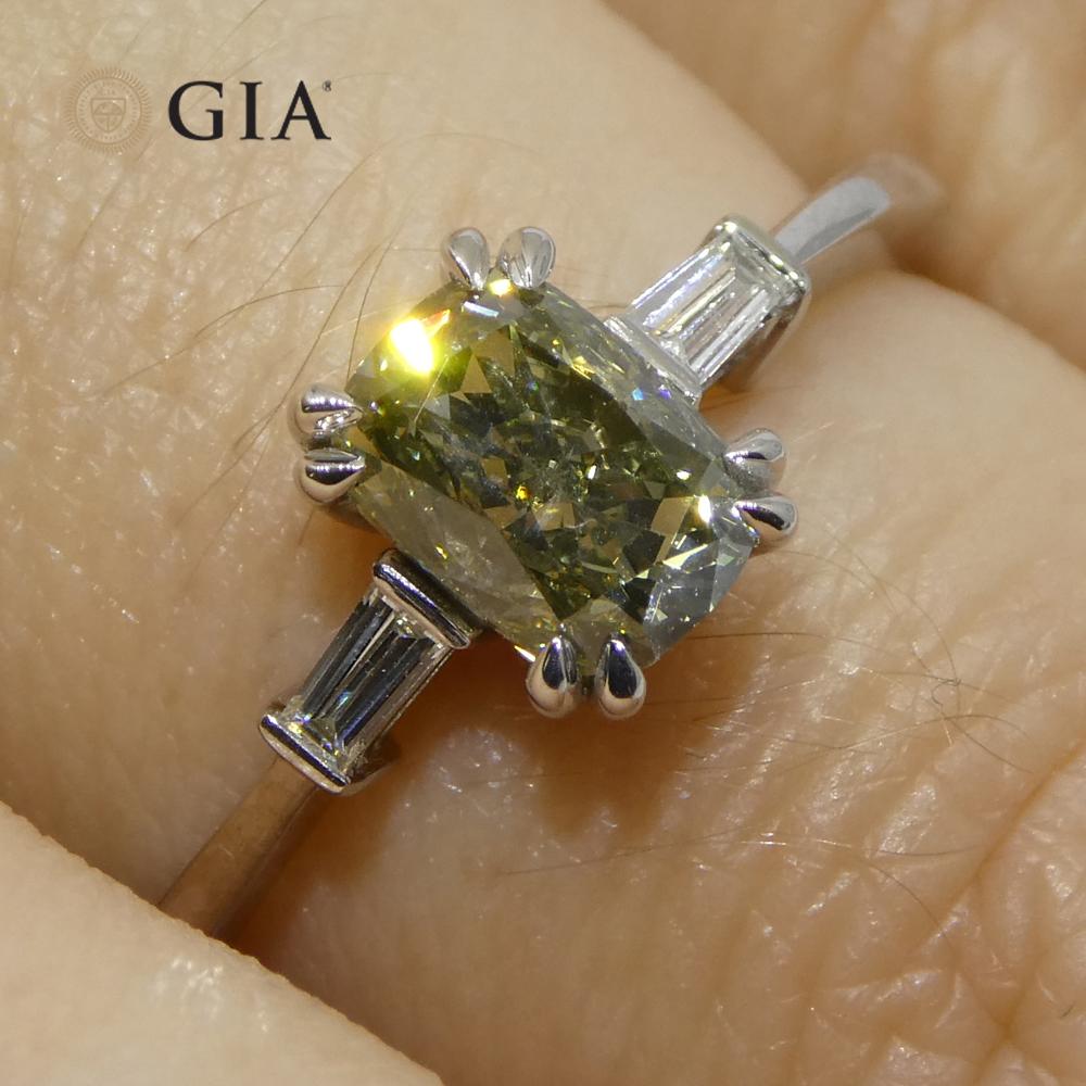 Introducing the epitome of distinctive elegance with our 1.07ct Yellowish Green Fancy Diamond Cushion Engagement Ring set in 18k White Gold. Each facet of this GIA-certified jewel is designed to showcase unparalleled brilliance and a unique