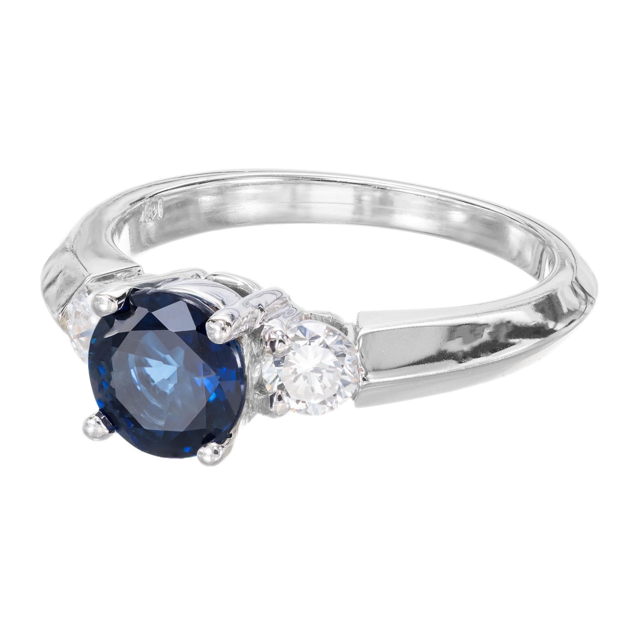 Round Sapphire and diamond engagement ring. AGL certified center sapphire in a 14k white gold three-stone setting with two round accent diamonds. 

1 Top gem bright blue Sapphire, approx. total weight 1.08cts, simple heat only, no other