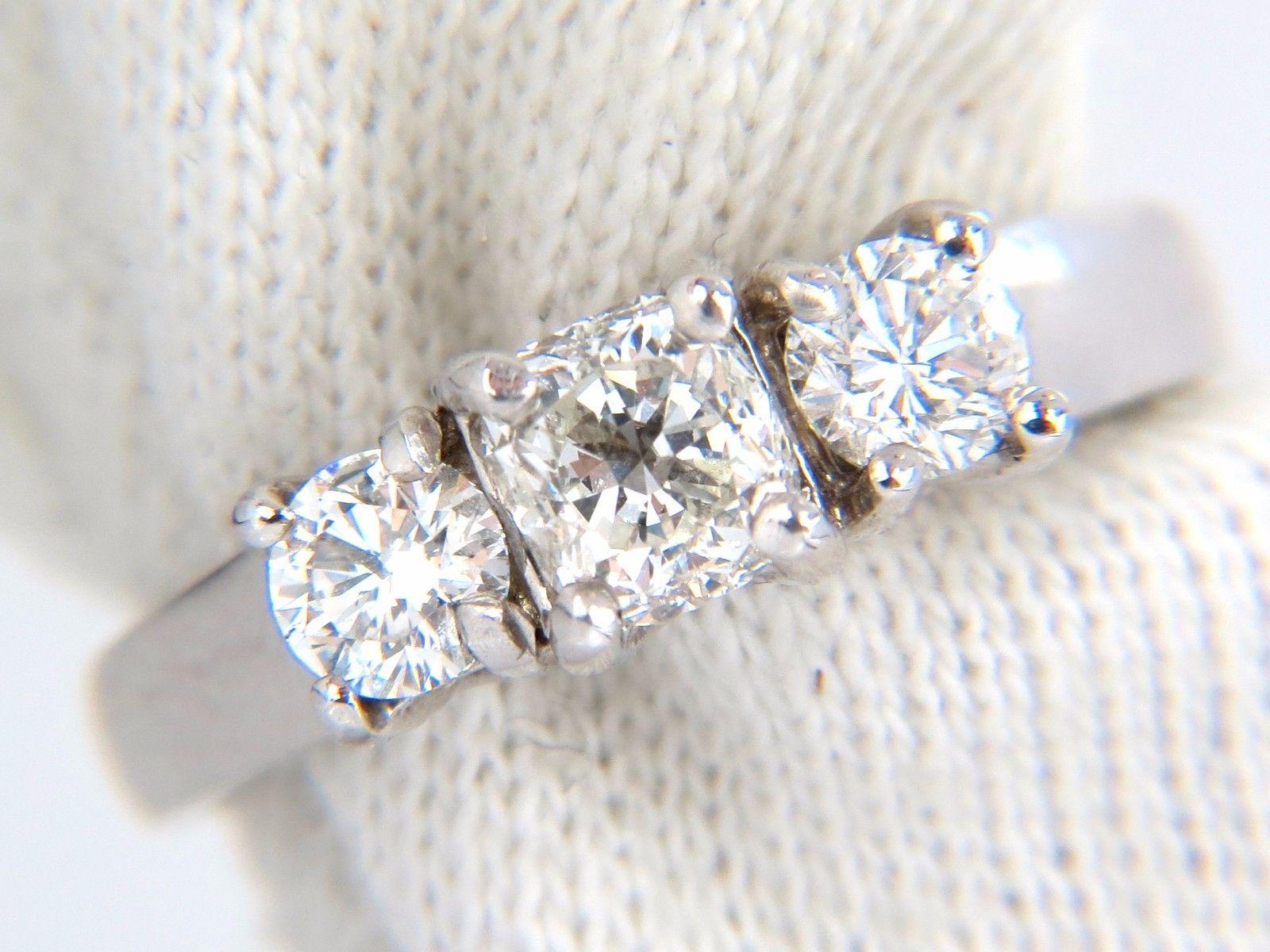 Cushion & Rounds 

.58ct. Center Cushion diamond & 
.40ct. side diamonds ring.

Classic Three

Center diamond: Cushion Brilliant & Full cut 
  
H- color & SI-1 clarity.

4.8 X 4.6mm

.50ct Side Diamonds: H-color, Si-1 clarity.
14kt. white