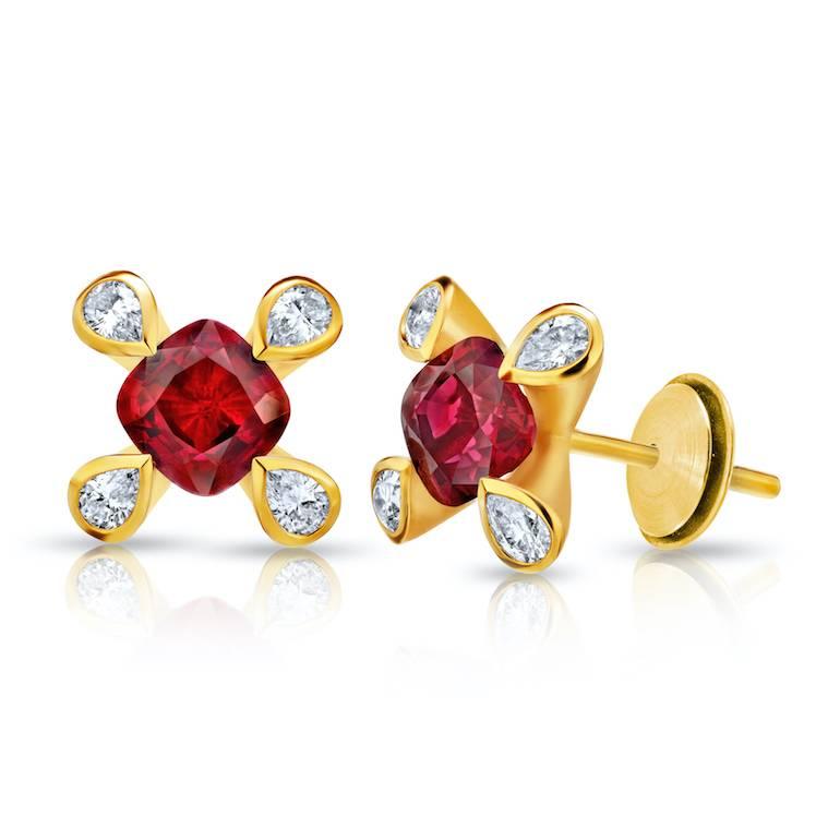 Two matched cushion cut red rubies weighing 1.08 carats set with eight pear shape diamonds (F+/VVS) weighing .21 carats in 18k yellow gold earrings
