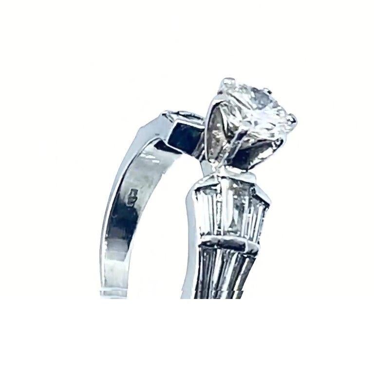 Round Cut 1.08 Carat Diamond Solitaire in Platinum with Baguette Shoulders For Sale