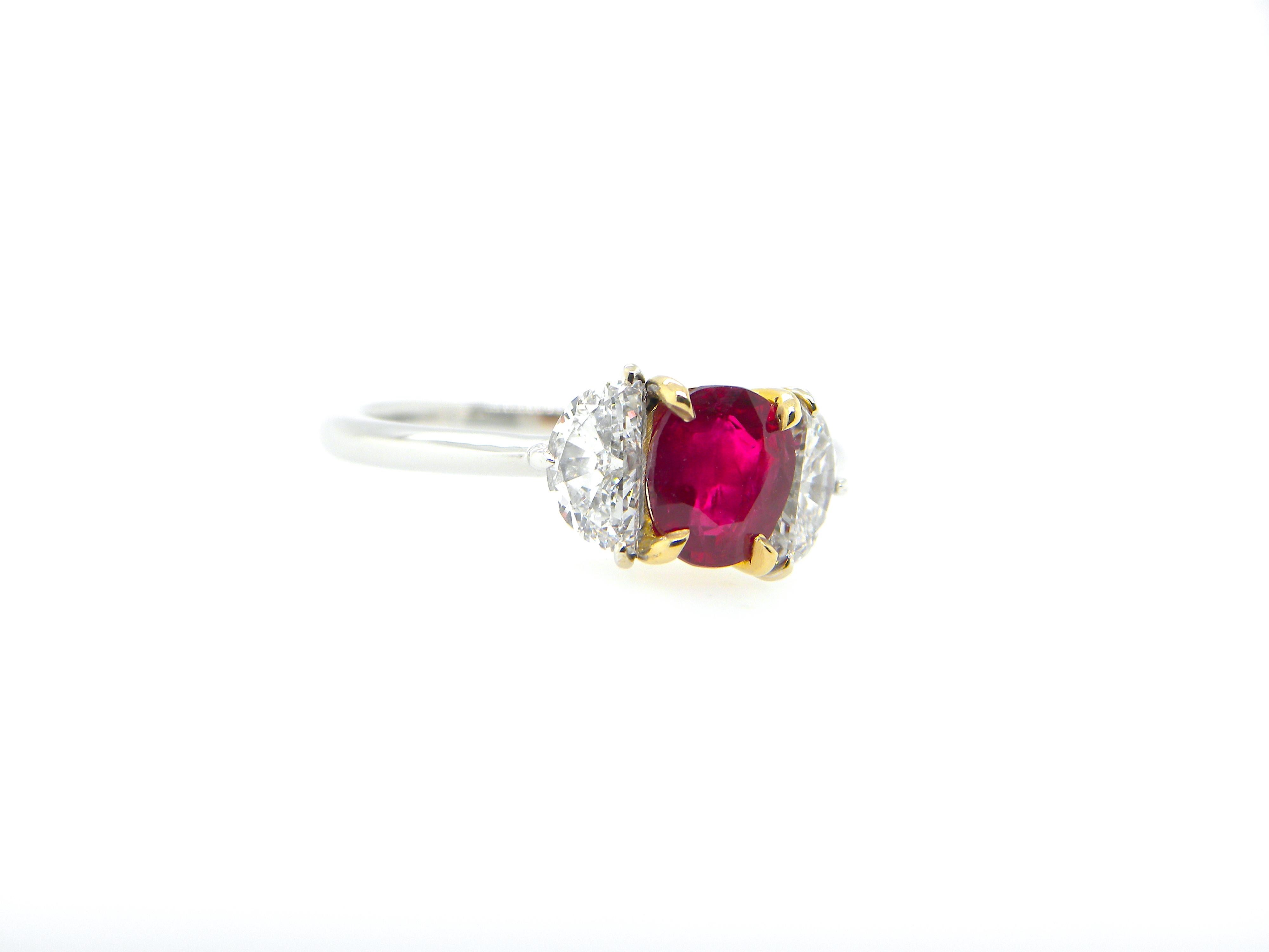 1.08 Carat GIA Certified Burma No Heat Pigeon's Blood Red Ruby and Diamond Ring:

A stunning three-stone ring, it features a rare GIA certified unheated Burmese pigeon's blood red ruby weighing 1.08 carat flanked by super-white half-moon cut