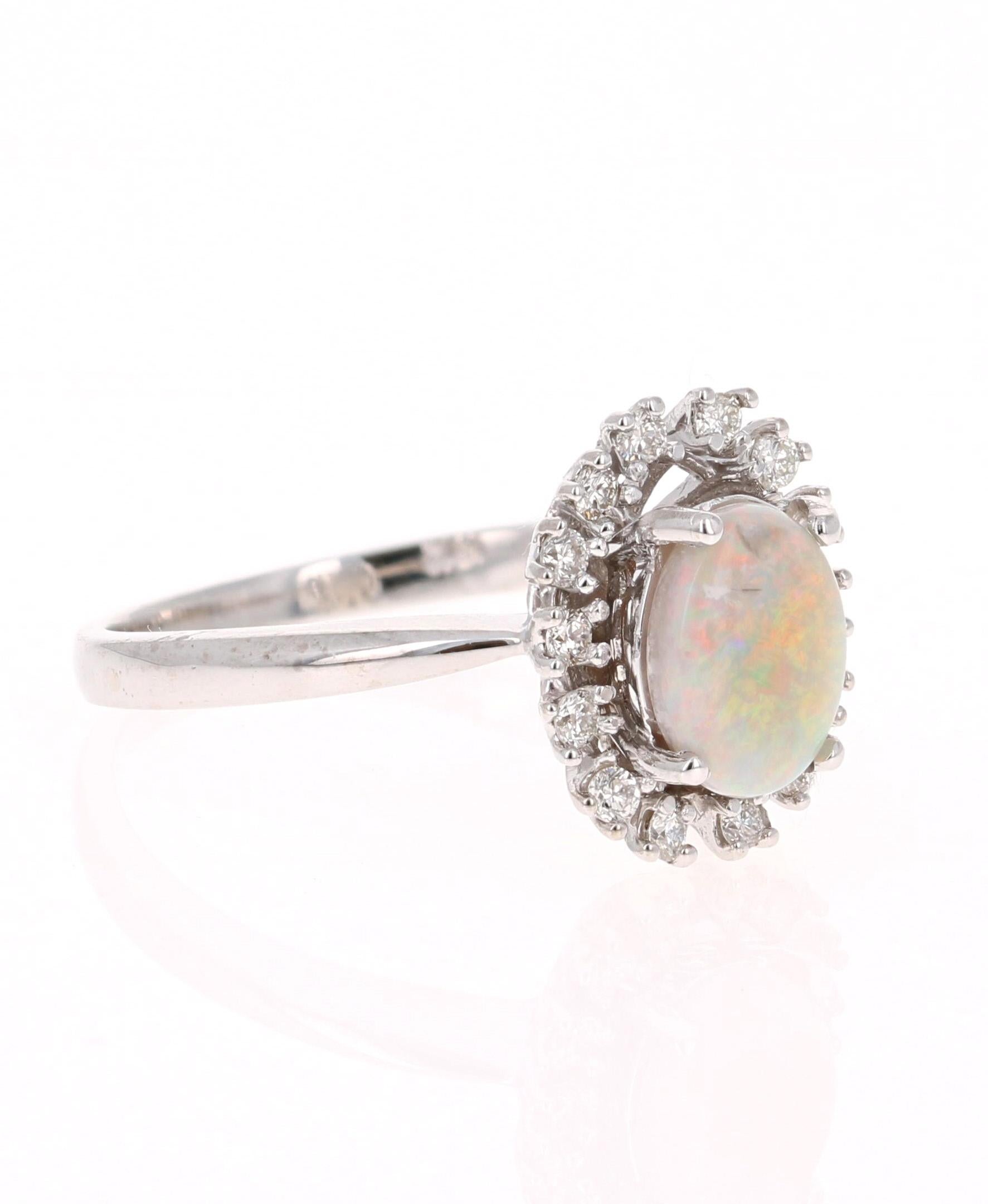 This ring has a cute and simple 0.85 Carat Opal and has 14 Round Cut Diamonds that weigh 0.23 Carats. (Clarity: VS, Color: H) The total carat weight of the ring is 1.08 Carats. 

The Opal displays beautiful flashes of yellow and orange and has its