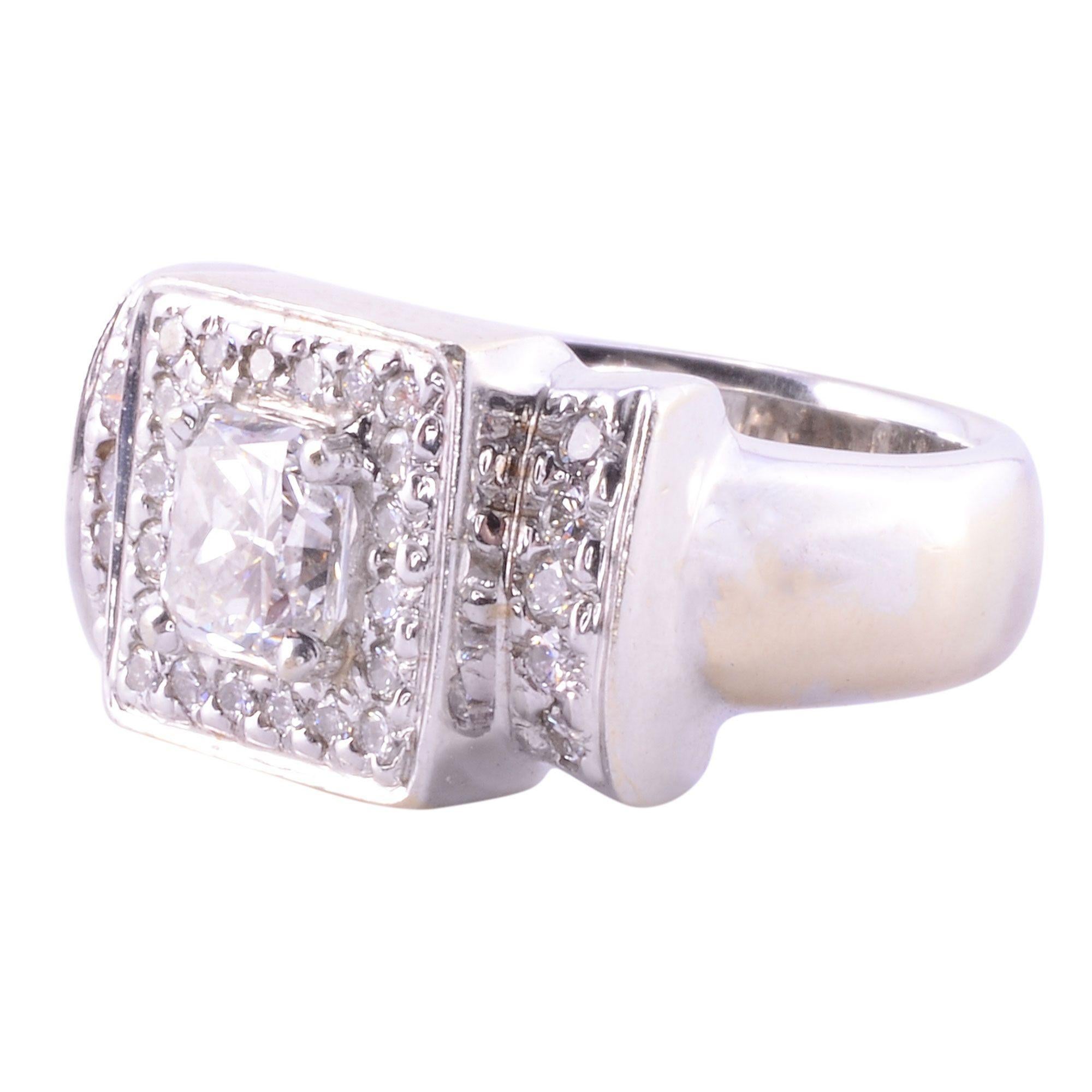 Estate 1.08 carat radiant cut VVS2 diamond ring. This 14 karat white gold fashion cluster ring is prong set with a center radiant cut diamond at approximately 1.08 carats that has VVS2 clarity and G color. This center diamond is encompassed with a