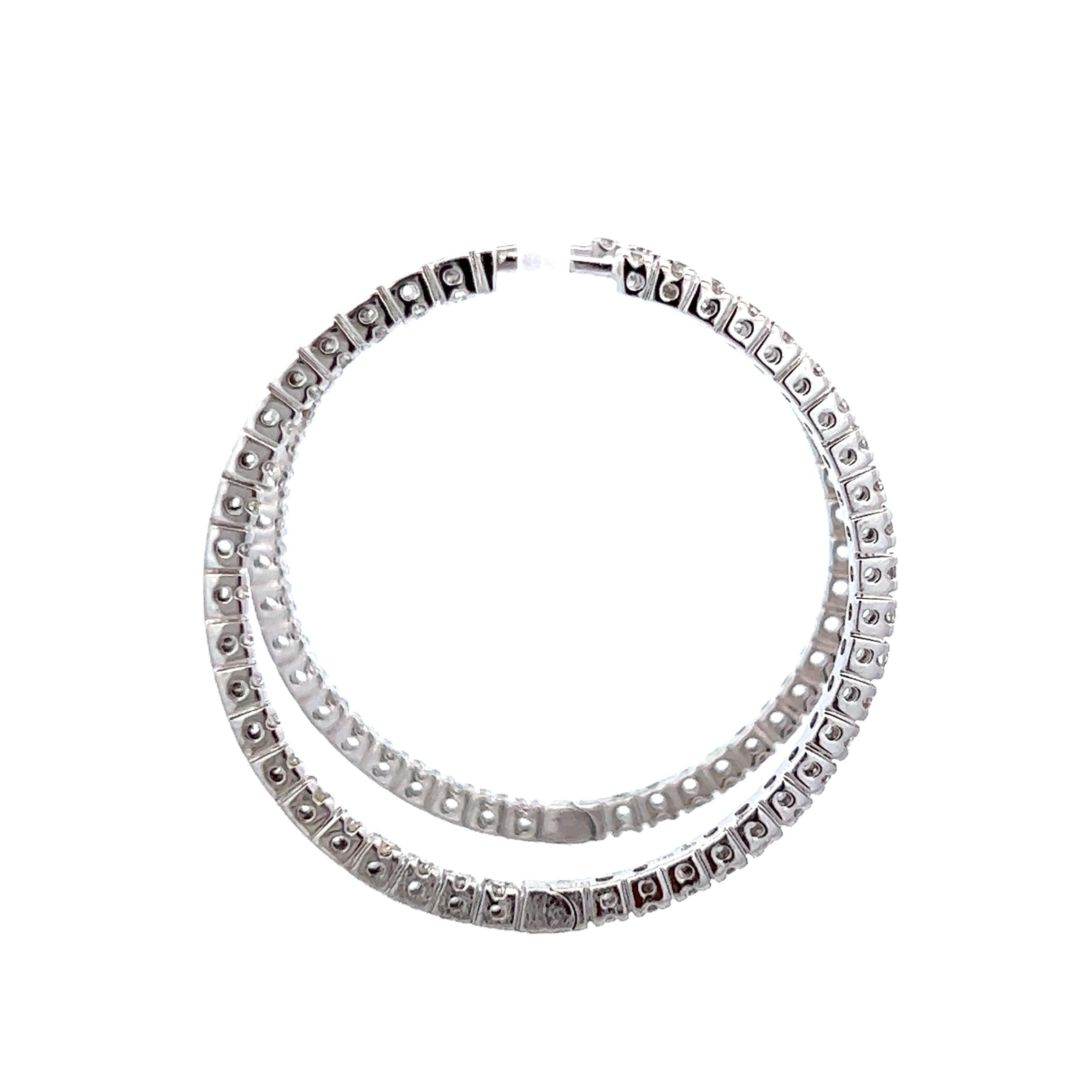 Classic round diamond hoop earrings.
84 round brilliant diamonds, 1.08 carats total. Approximately H/I color and SI clarity. Four prong set 14k white gold, 7.42 grams.
Accommodated with an up to date digital appraisal by a GIA G.G., once purchased,