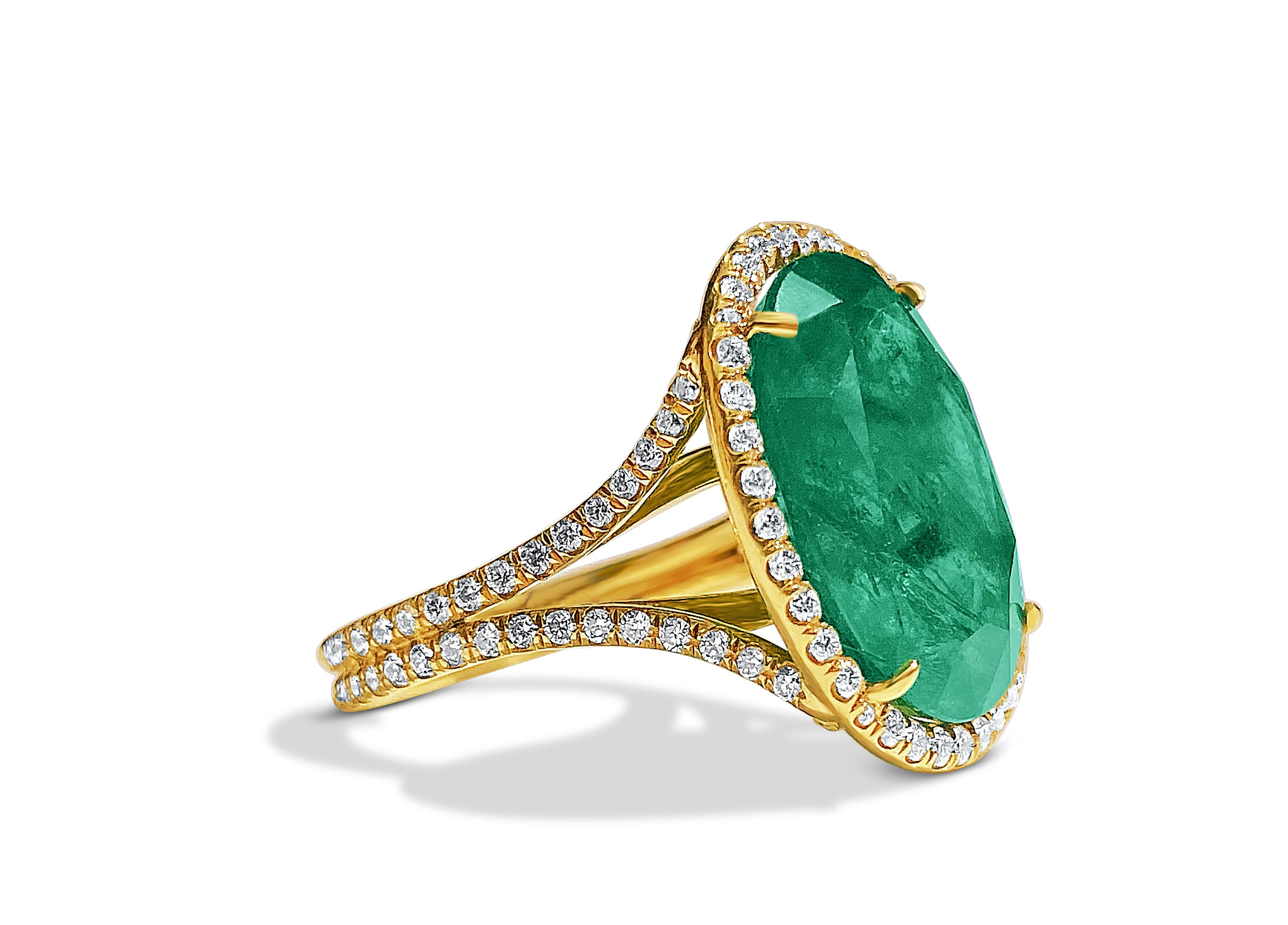 Centering a 10.80 Carat Oval-Cut Emerald, framed by an additional 1.60 carats of Round-Brilliant Cut Diamonds, and set in 18K Yellow Gold, this vintage gem 

Ring setting is brilliantly handmade with two elevated ball points in the rings interior,